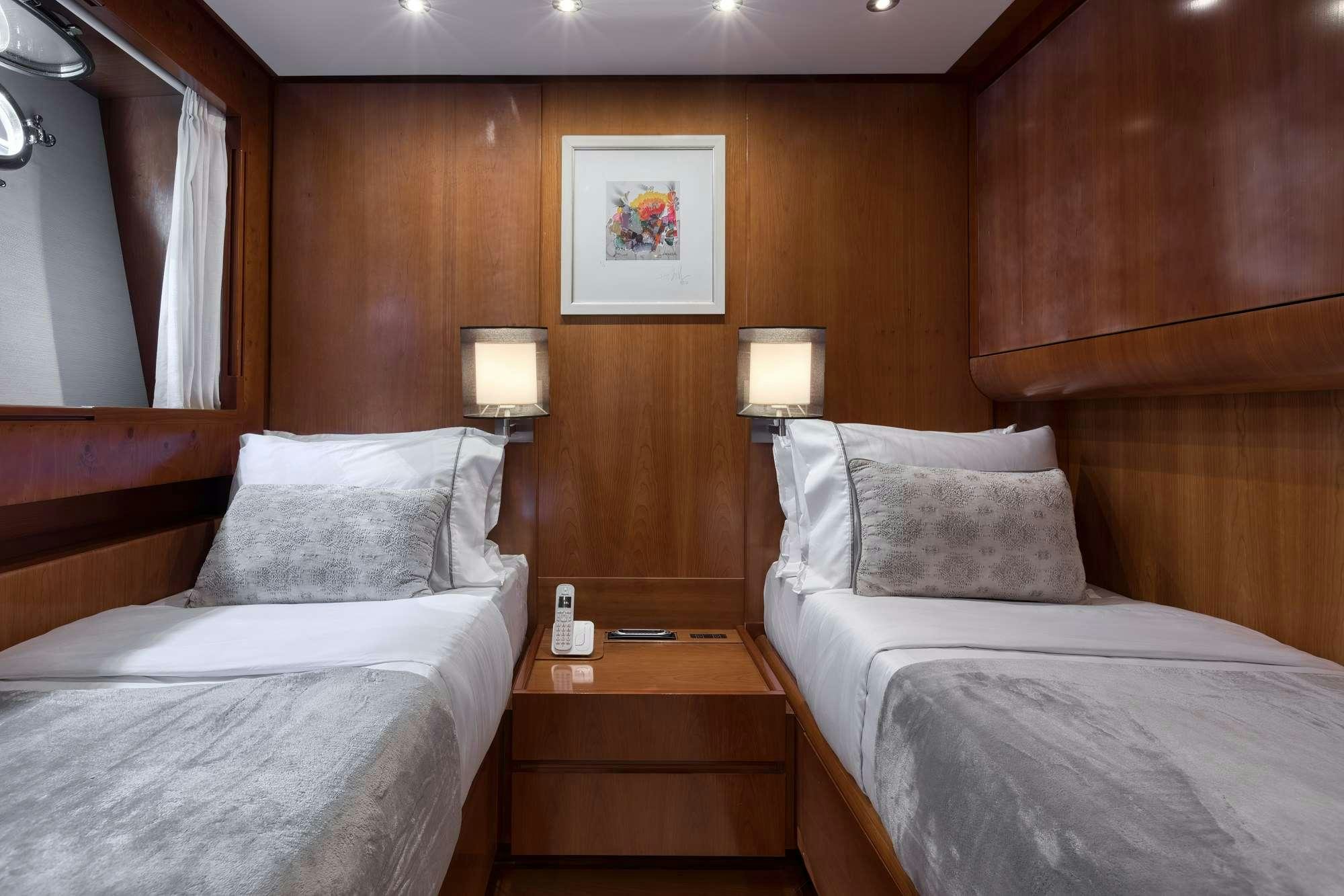 a couple of beds in a hotel room aboard WHY Yacht for Charter