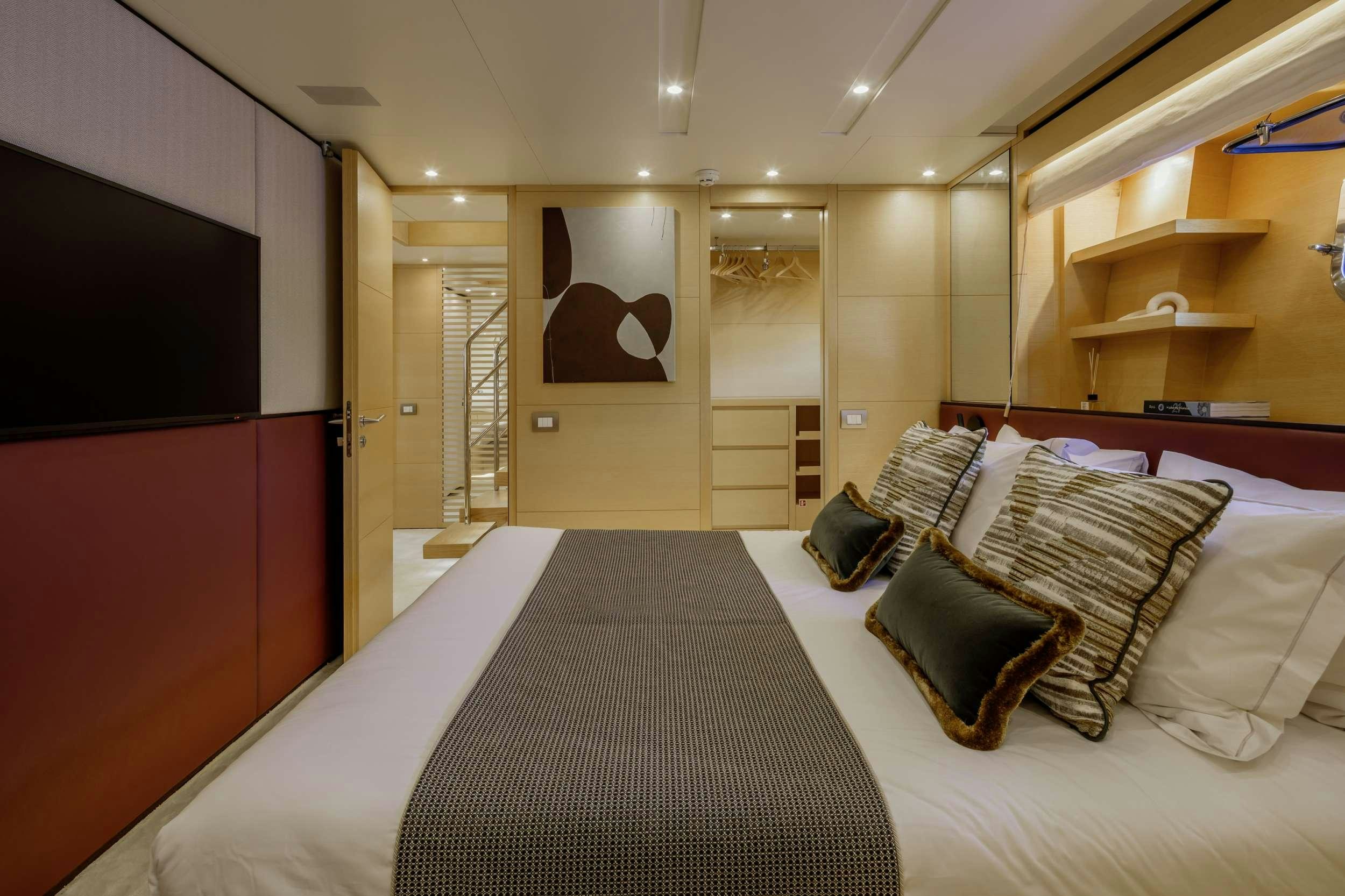 a large bedroom with a large bed aboard ELYSIUM Yacht for Charter