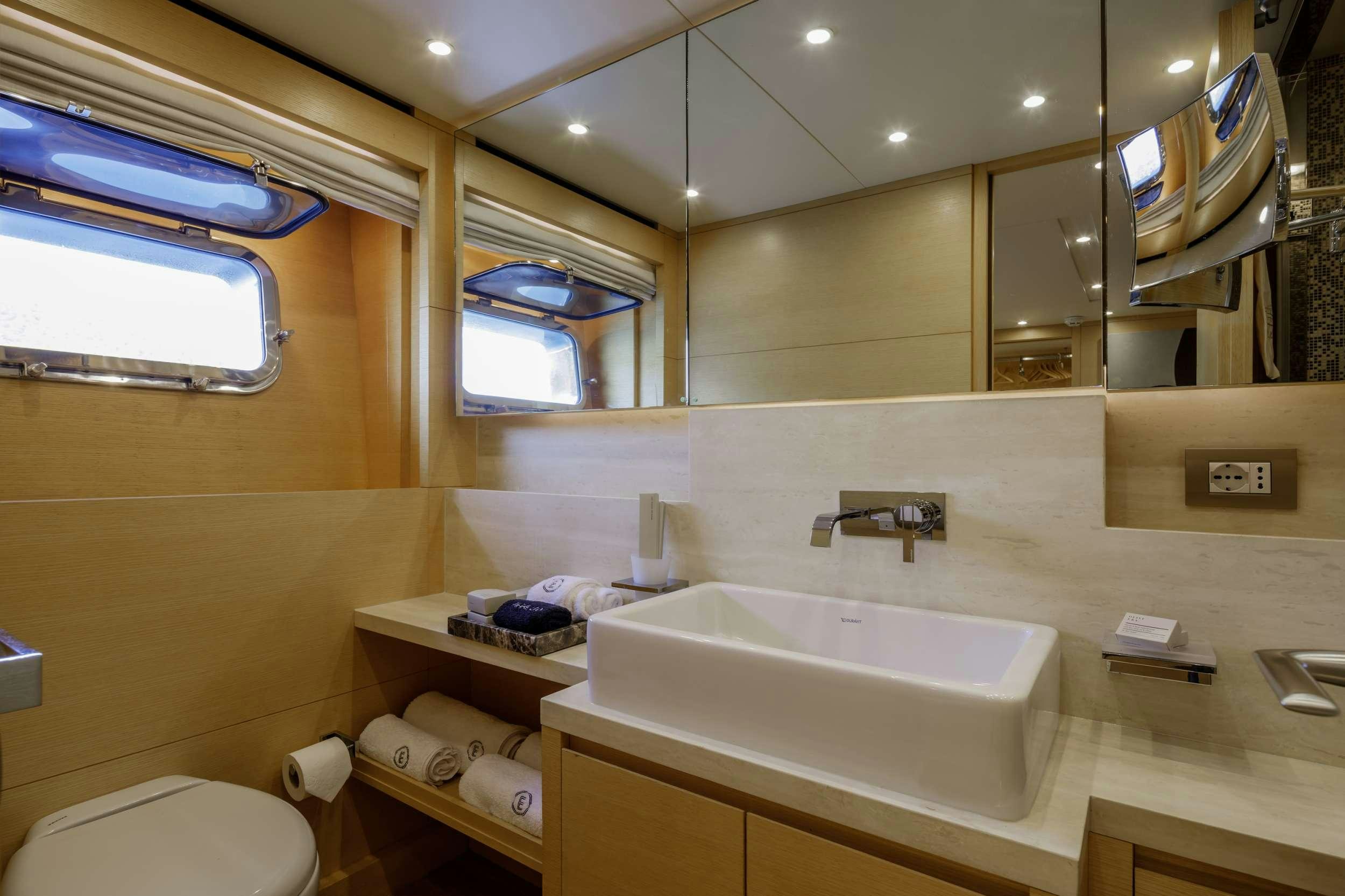 a bathroom with a sink and mirror aboard ELYSIUM Yacht for Charter
