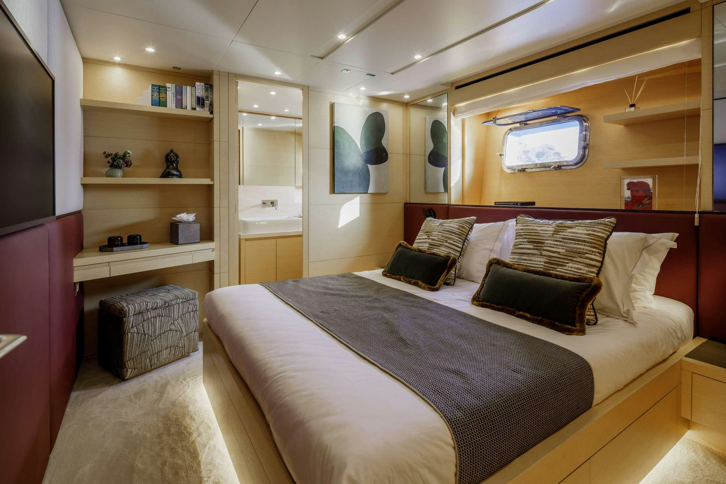 a bedroom with a bed and a shelf aboard ELYSIUM Yacht for Charter