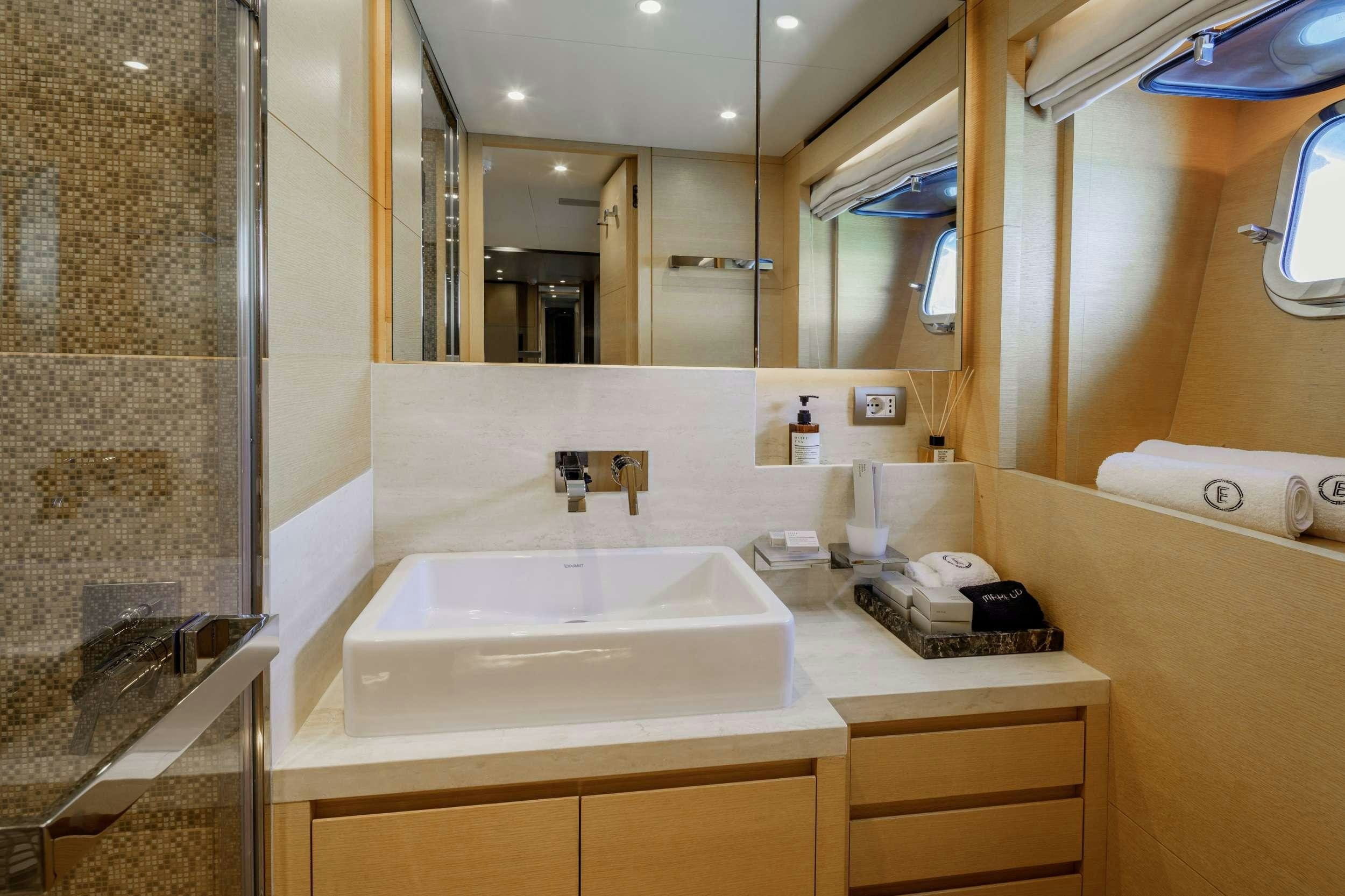 a bathroom with a large mirror aboard ELYSIUM Yacht for Charter