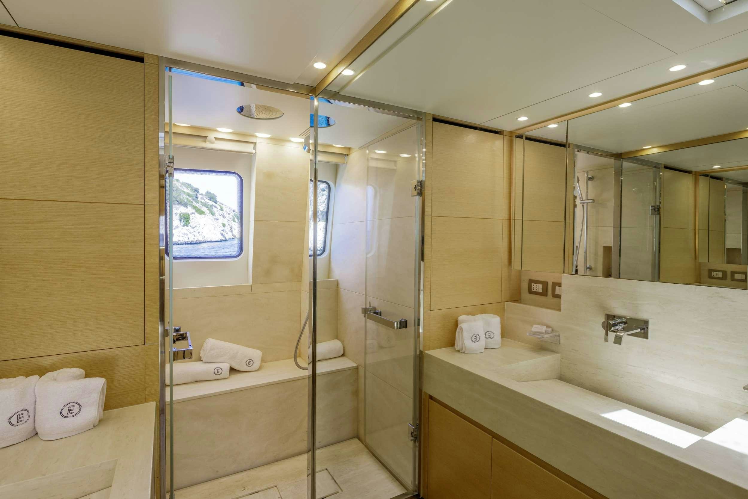 a bathroom with a glass shower aboard ELYSIUM Yacht for Charter