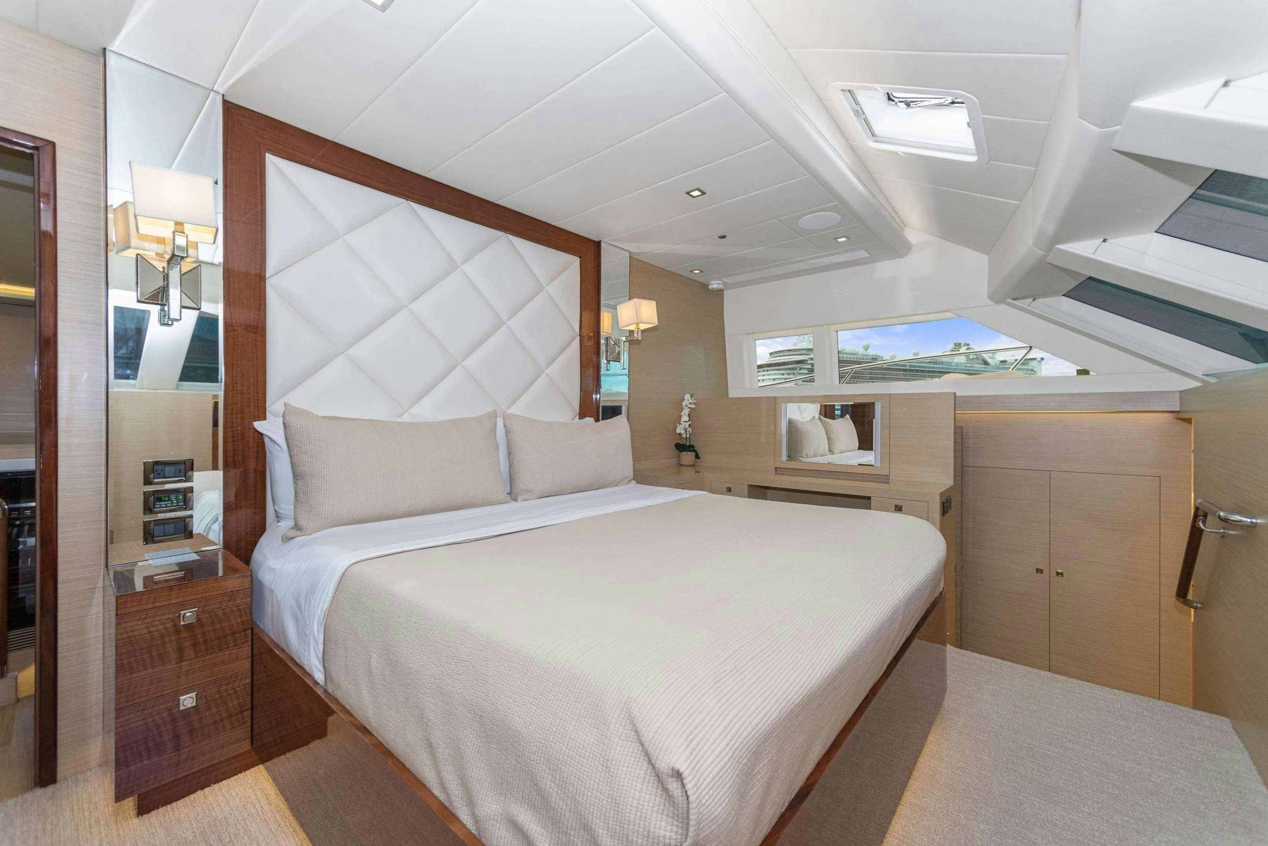 a bedroom with a bed and a television aboard SALUS Yacht for Charter