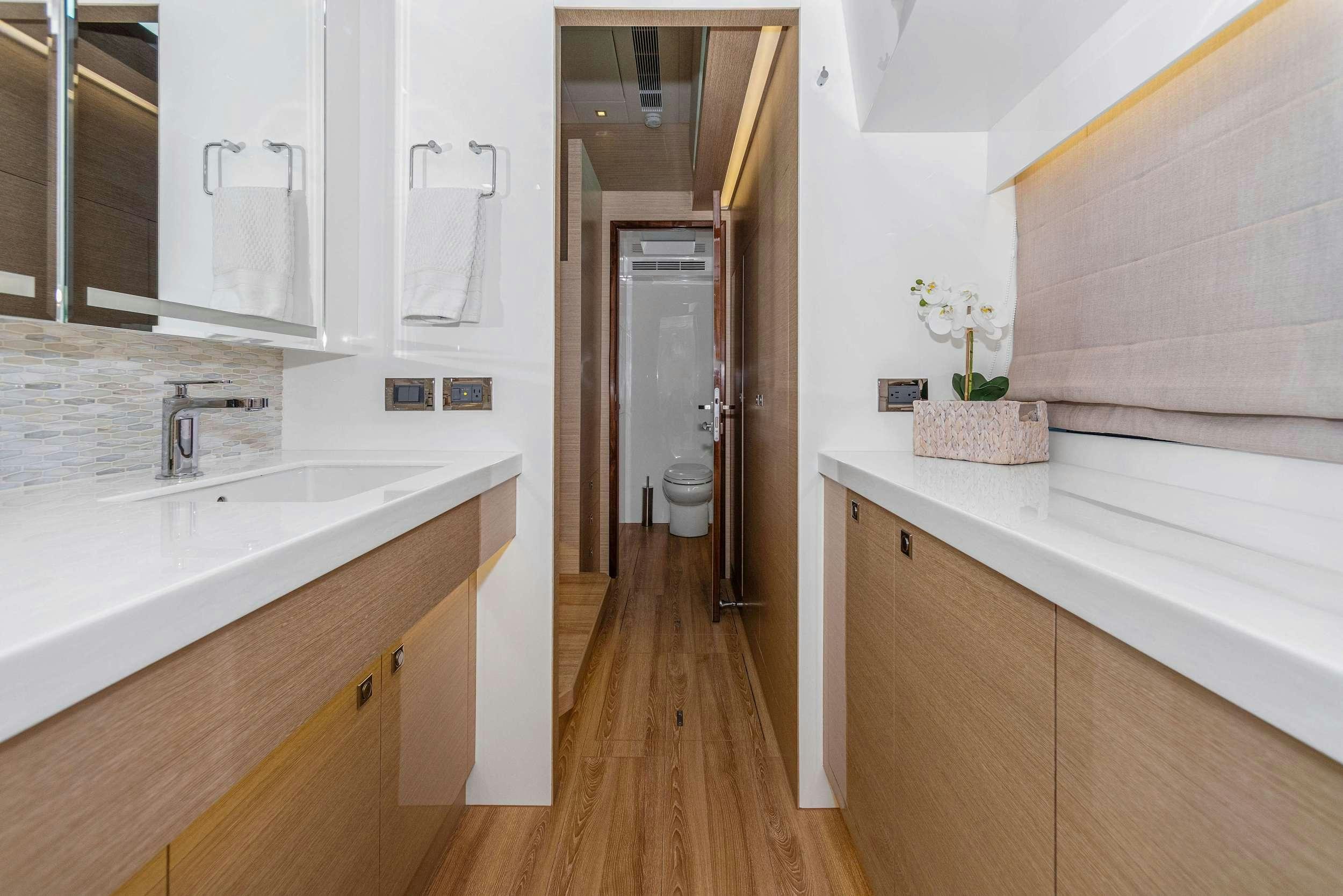 a bathroom with a tub sink and toilet aboard SALUS Yacht for Charter