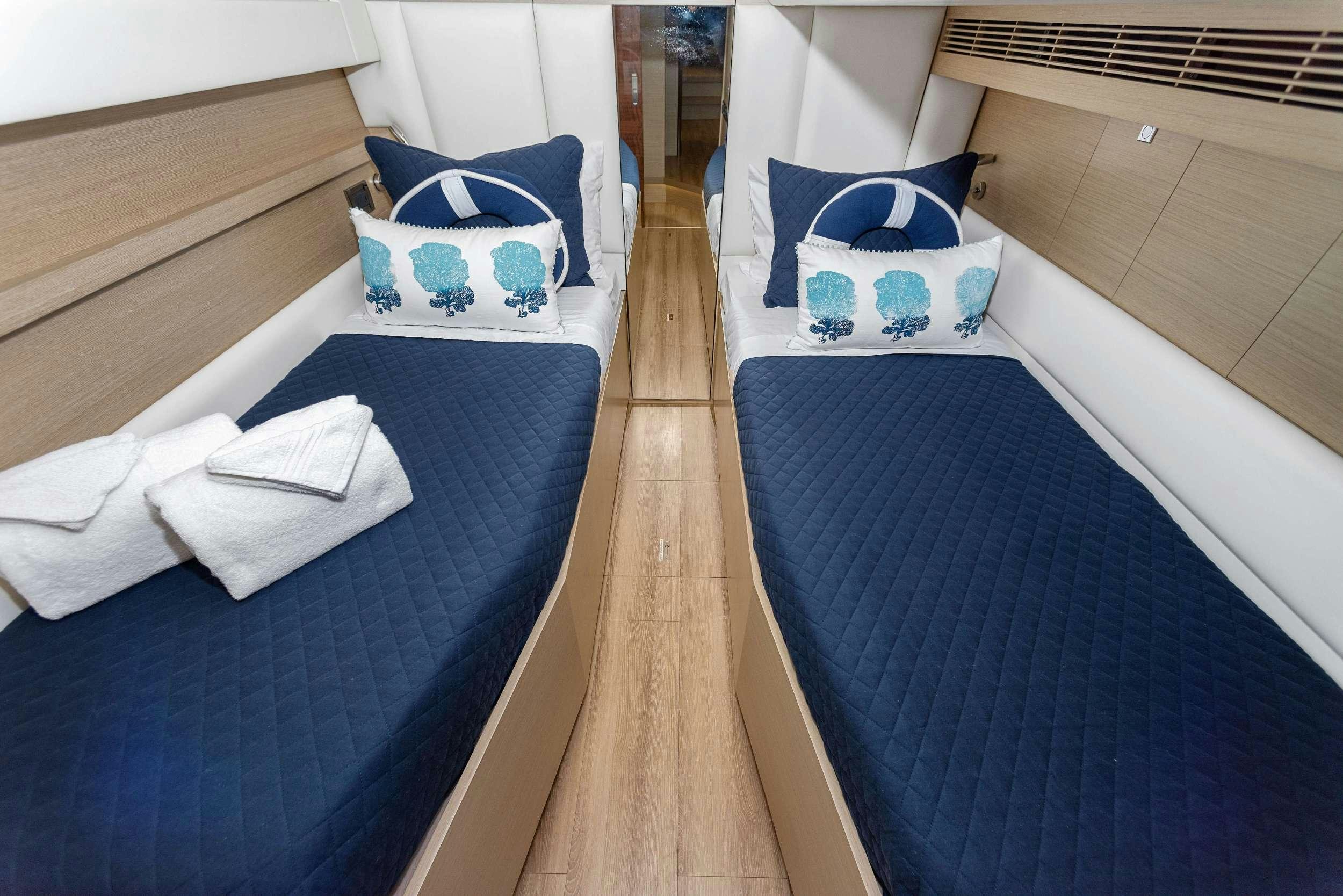 a room with a bed and a blue and white bed aboard SALUS Yacht for Charter