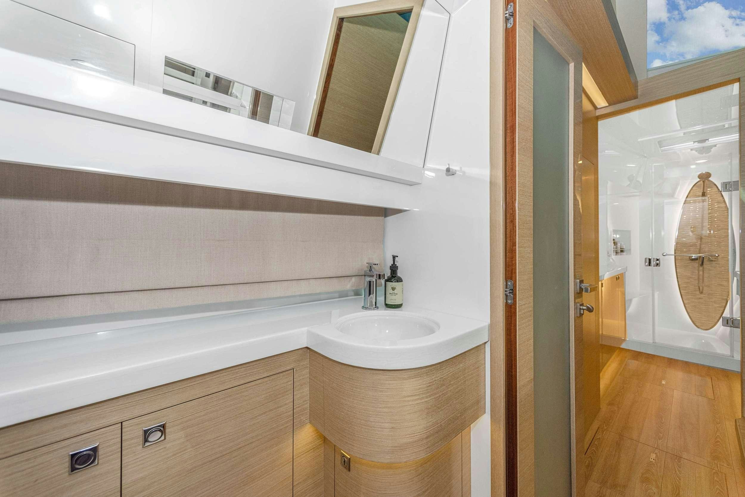 a bathroom with a tub sink and mirror aboard SALUS Yacht for Charter