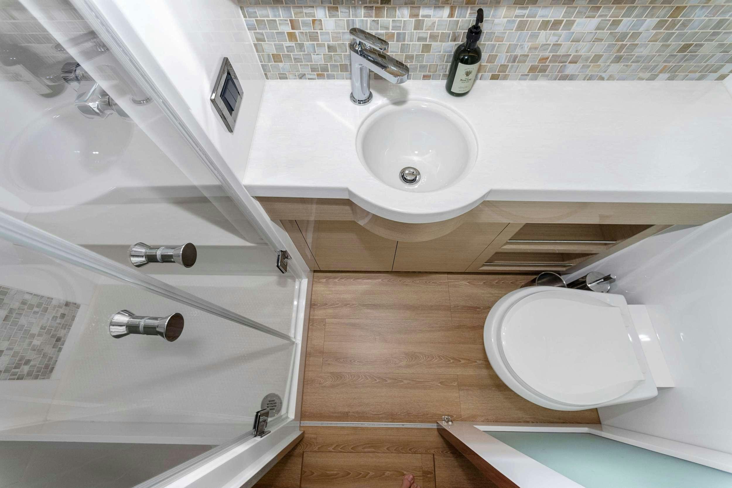 a bathroom with a toilet and sink aboard SALUS Yacht for Charter