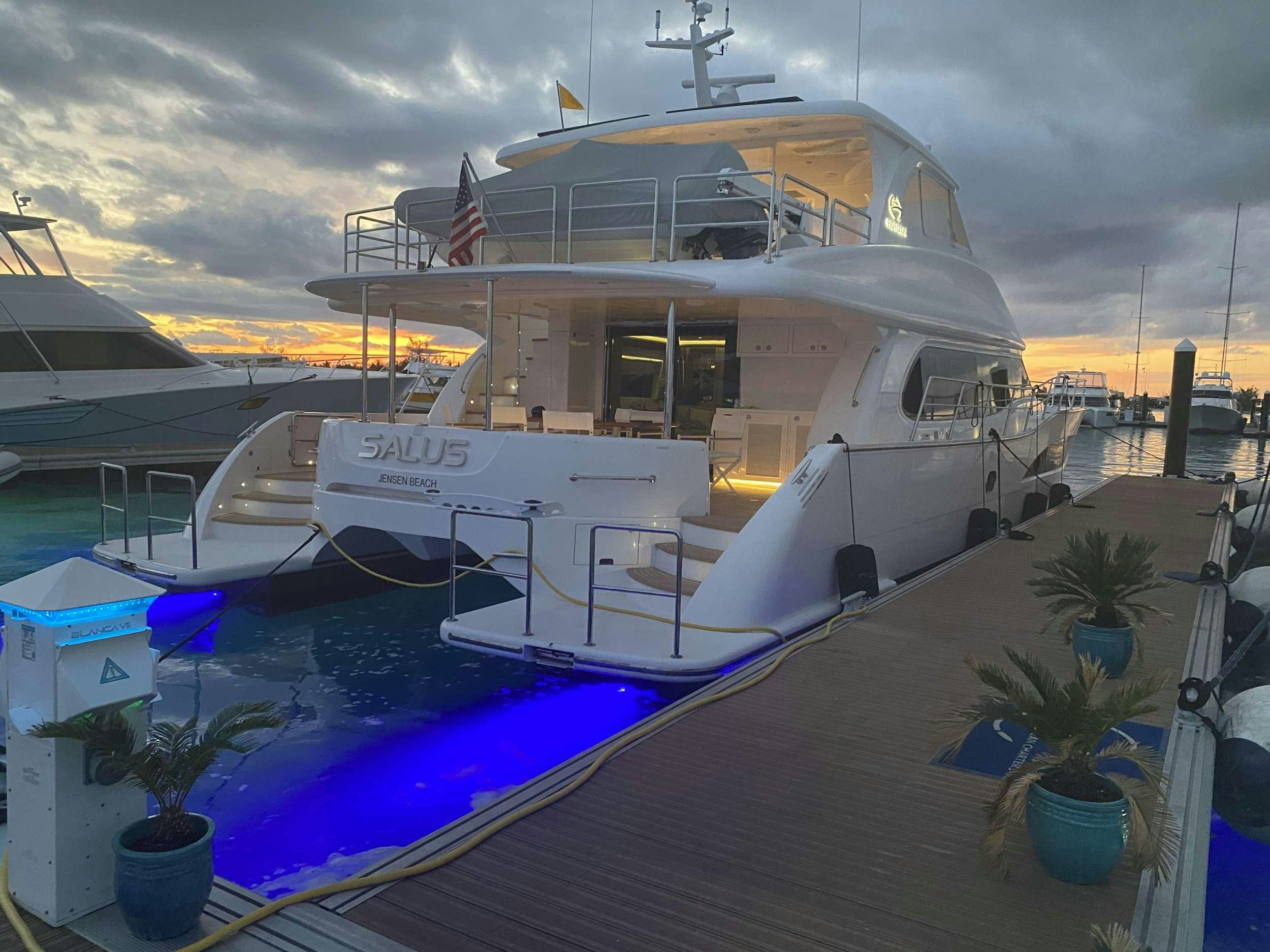 a boat docked at a dock aboard SALUS Yacht for Charter