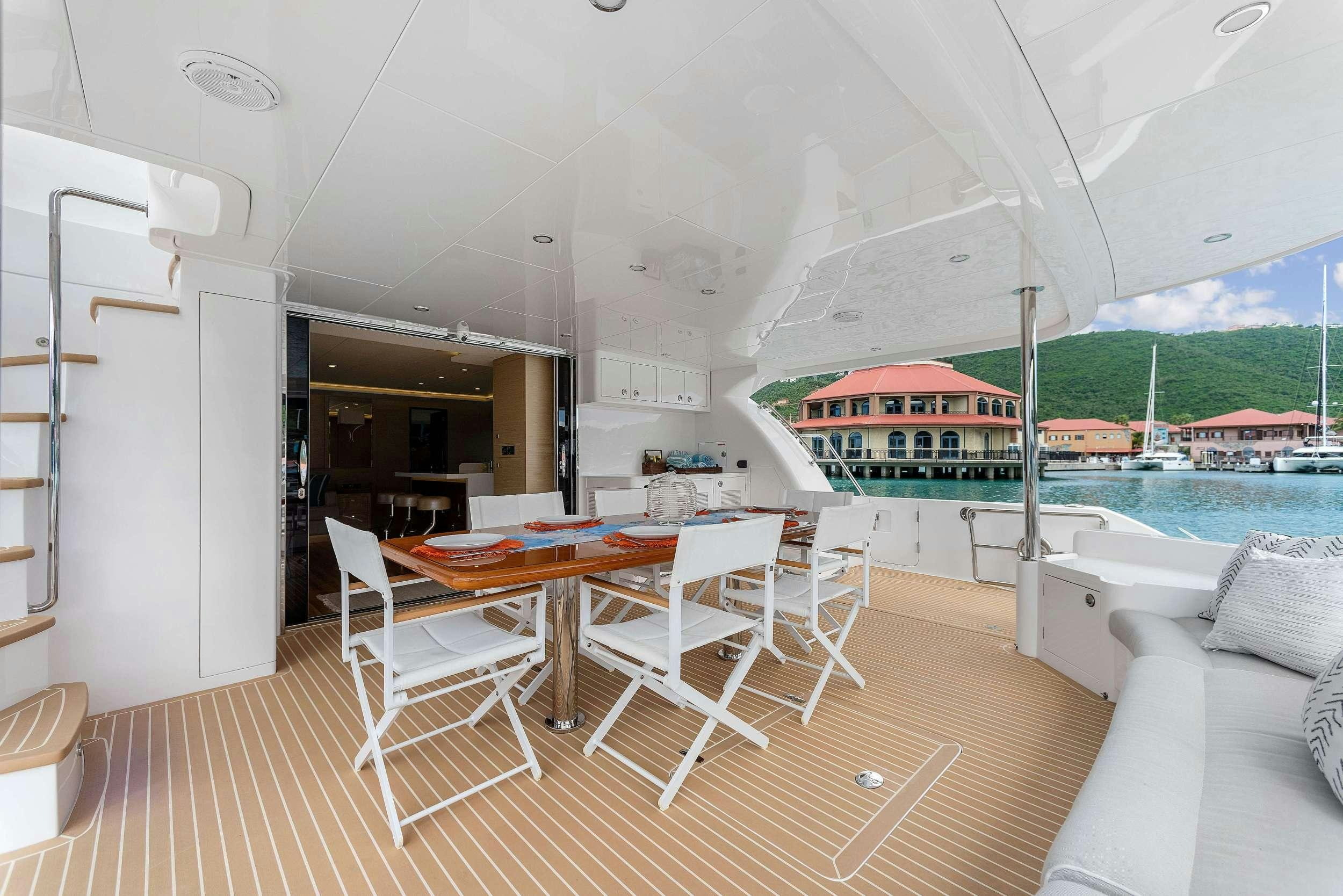 a room with tables and chairs aboard SALUS Yacht for Charter