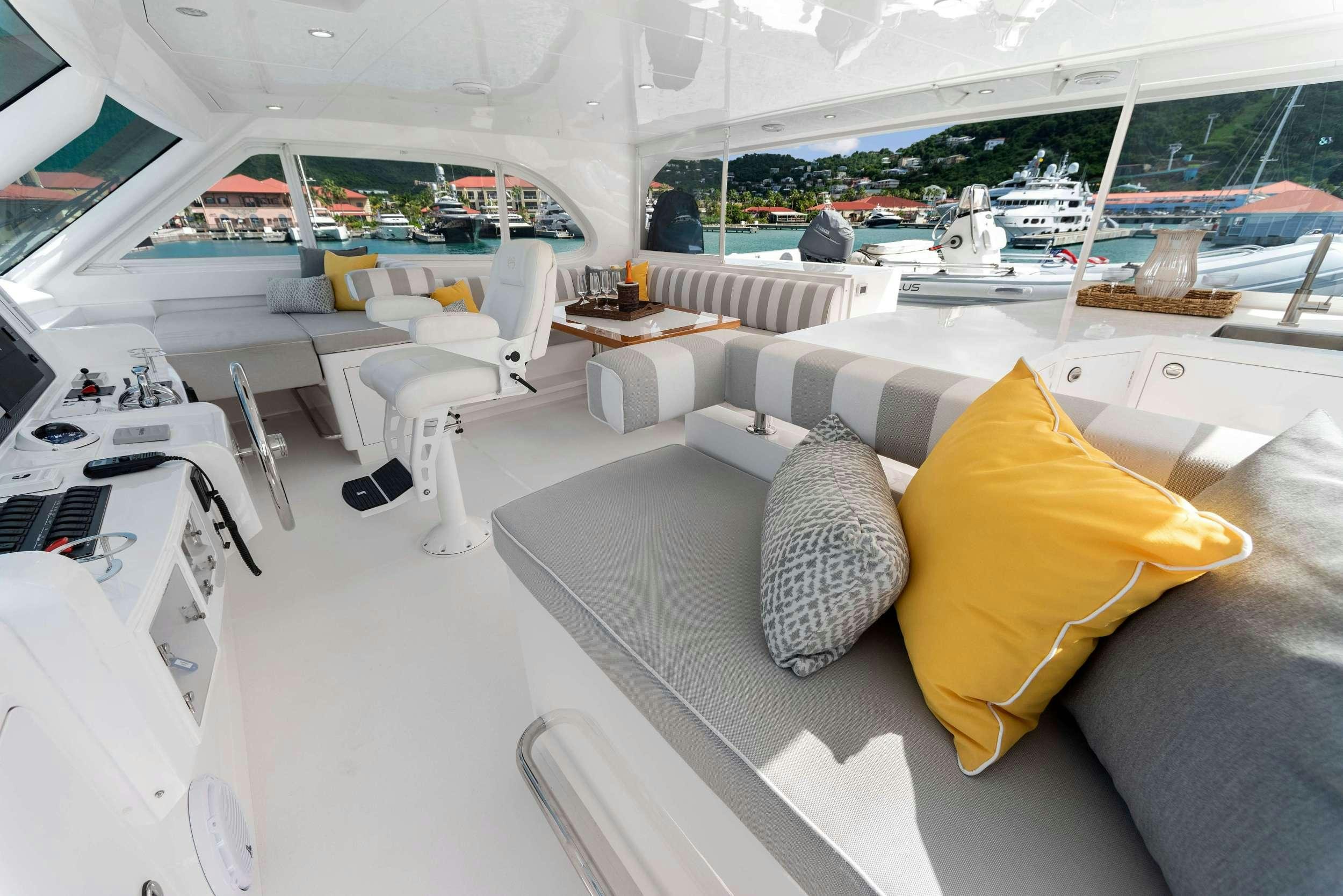 a room with a couch and chairs aboard SALUS Yacht for Charter