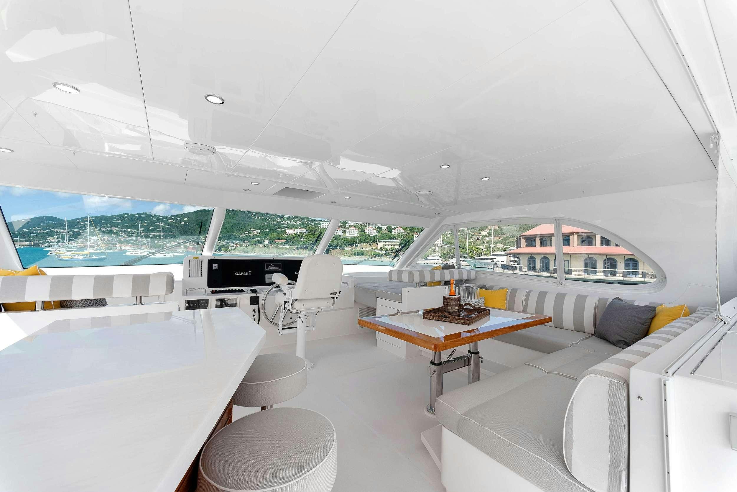 a room with a table and chairs aboard SALUS Yacht for Charter