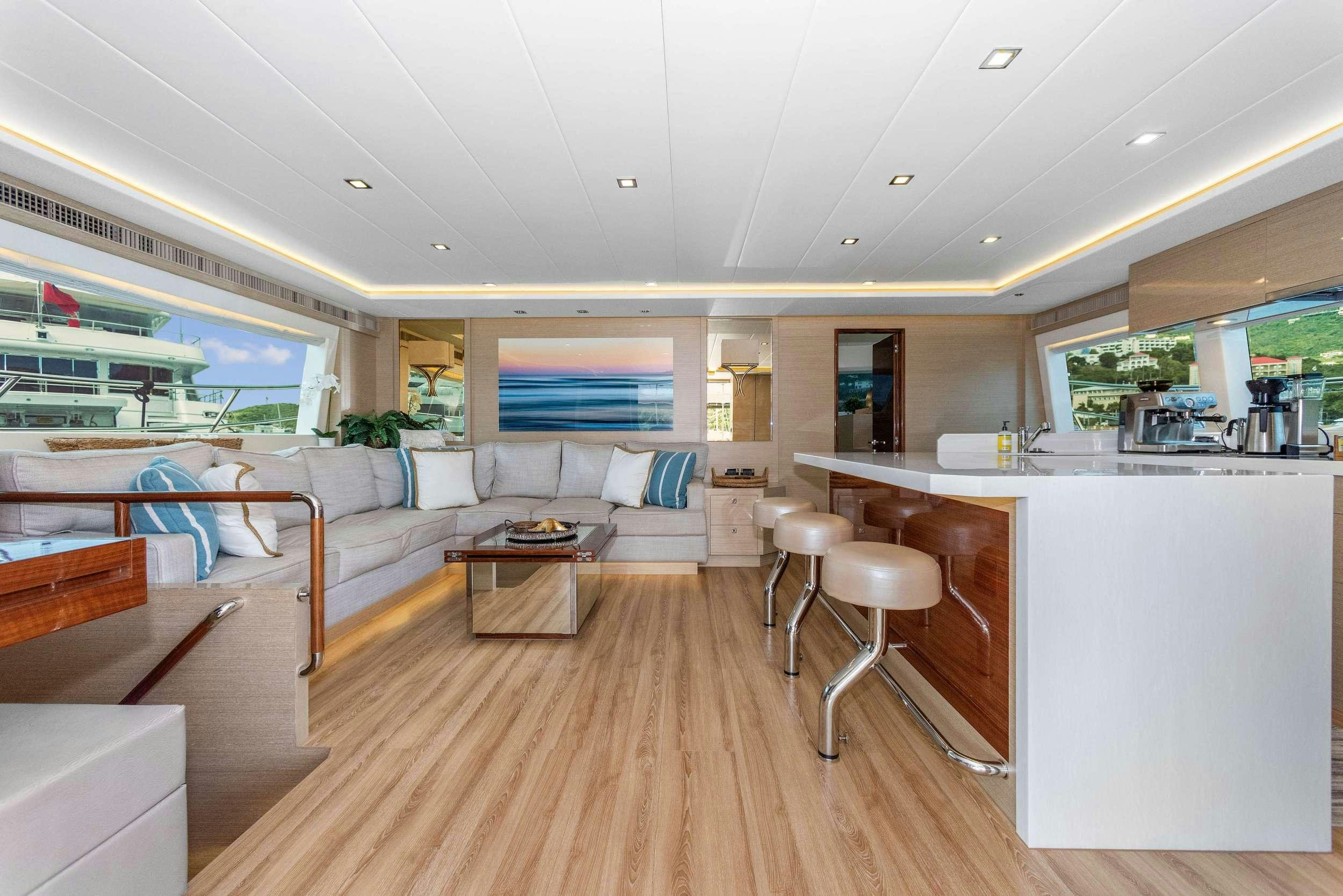 a living room with a wood floor aboard SALUS Yacht for Charter
