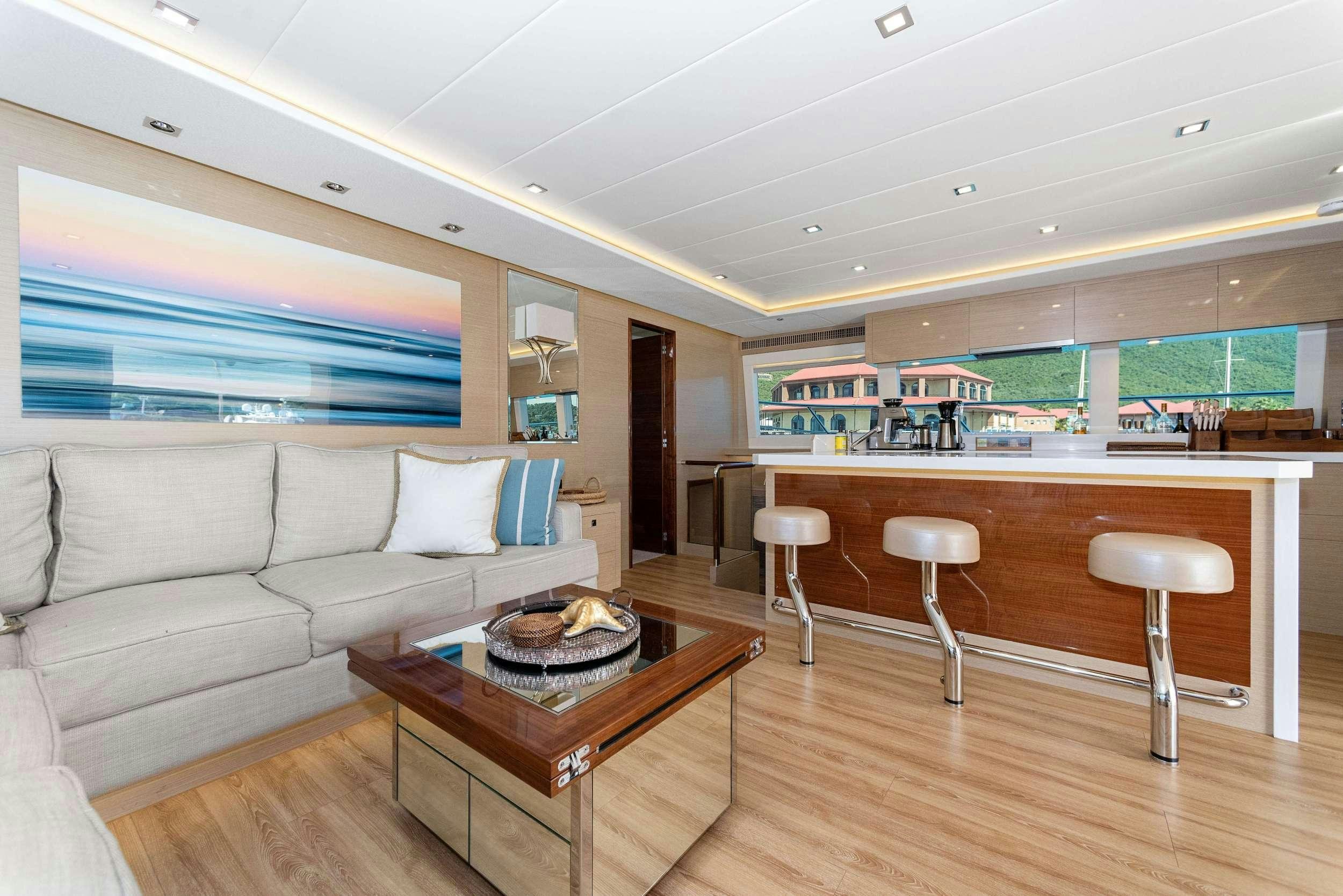 a living room with a couch and a coffee table aboard SALUS Yacht for Charter