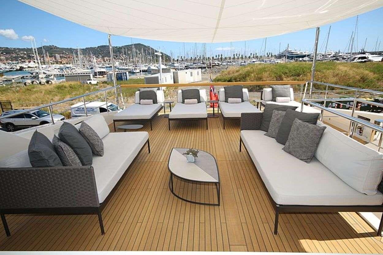 a room with a couch and a table and chairs aboard OCTAVE Yacht for Charter