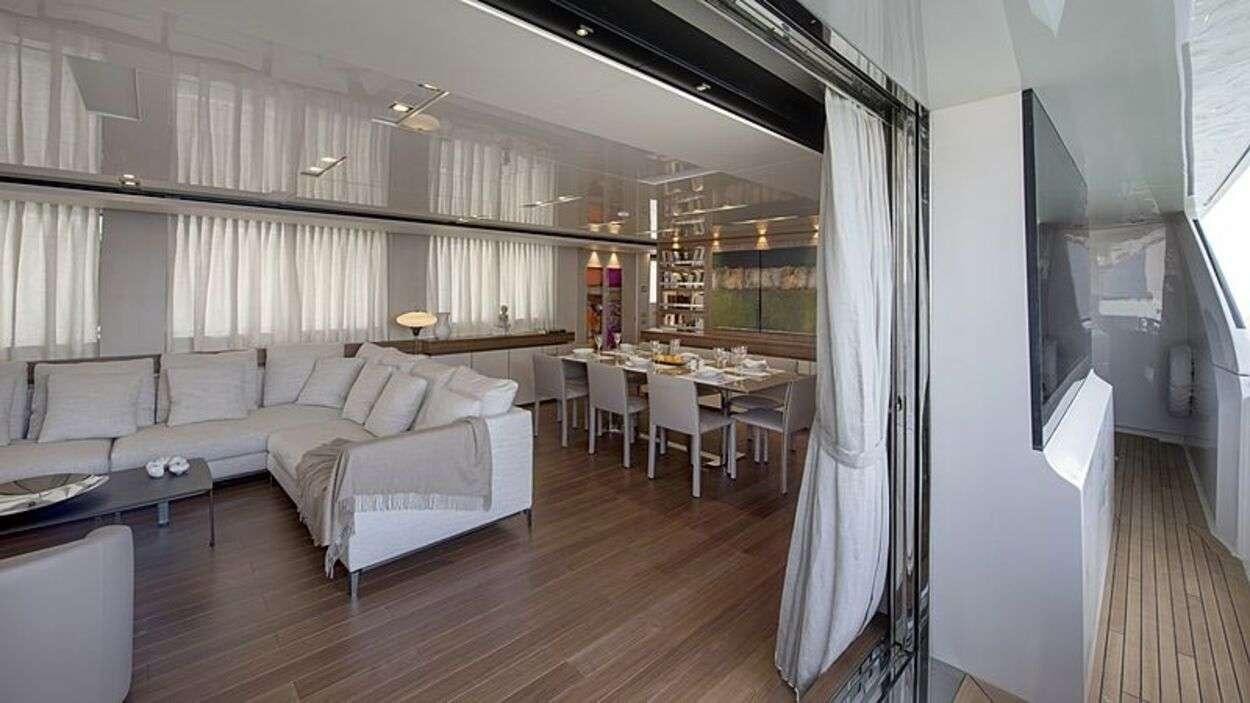 a room with a bed and a table aboard OCTAVE Yacht for Charter