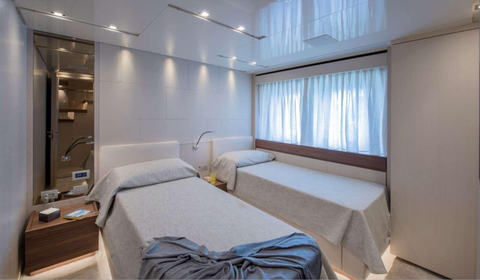 a couple of beds in a room aboard OCTAVE Yacht for Charter