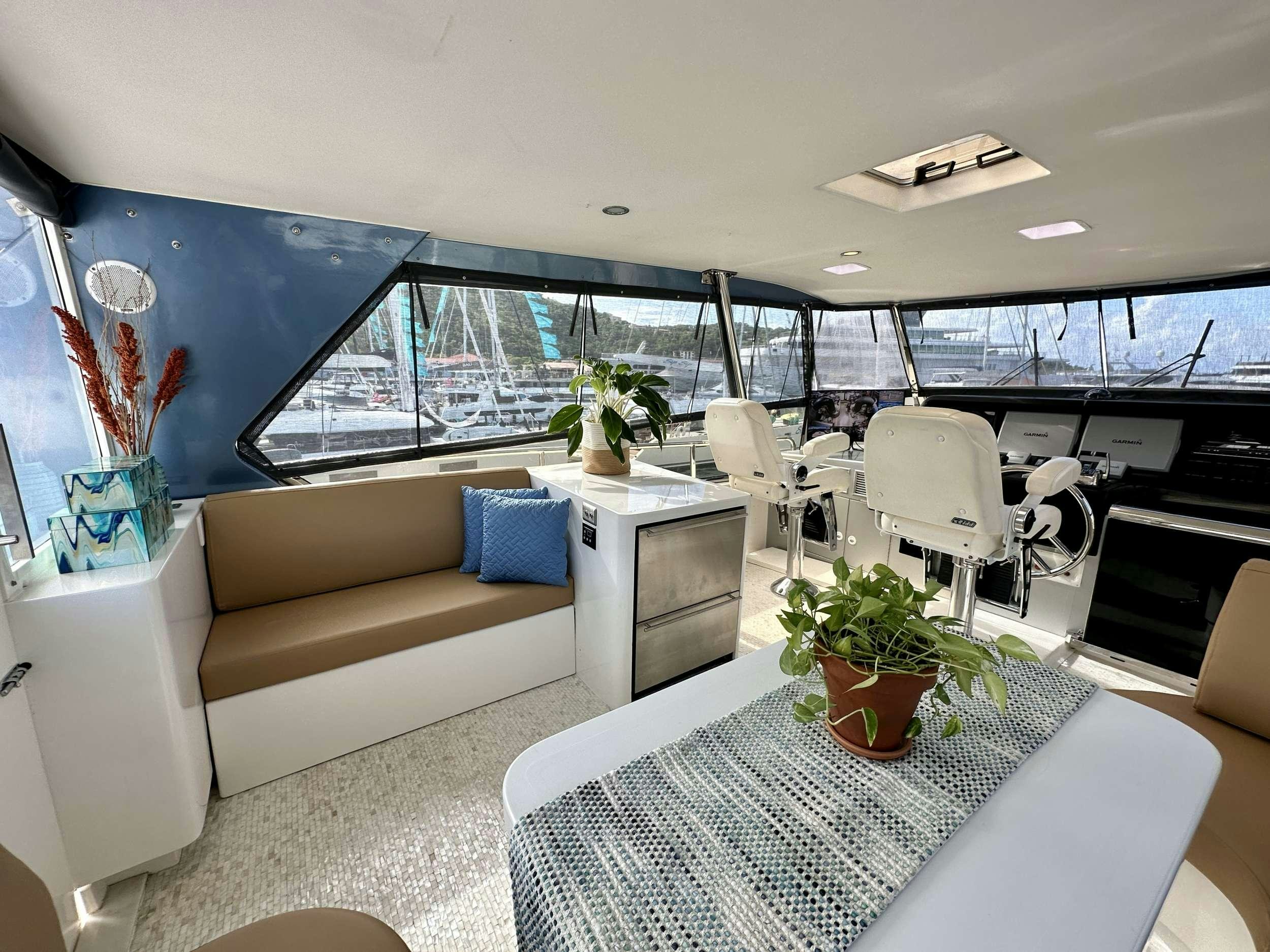 a living room with a large window aboard QARA Yacht for Charter