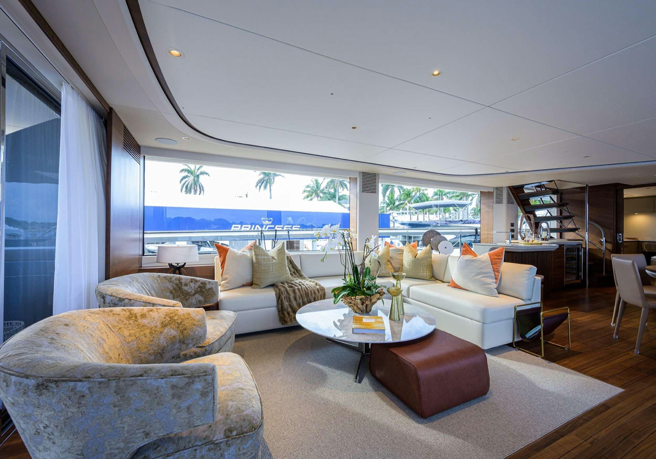 a living room with a large window aboard MONOPOLY Yacht for Charter
