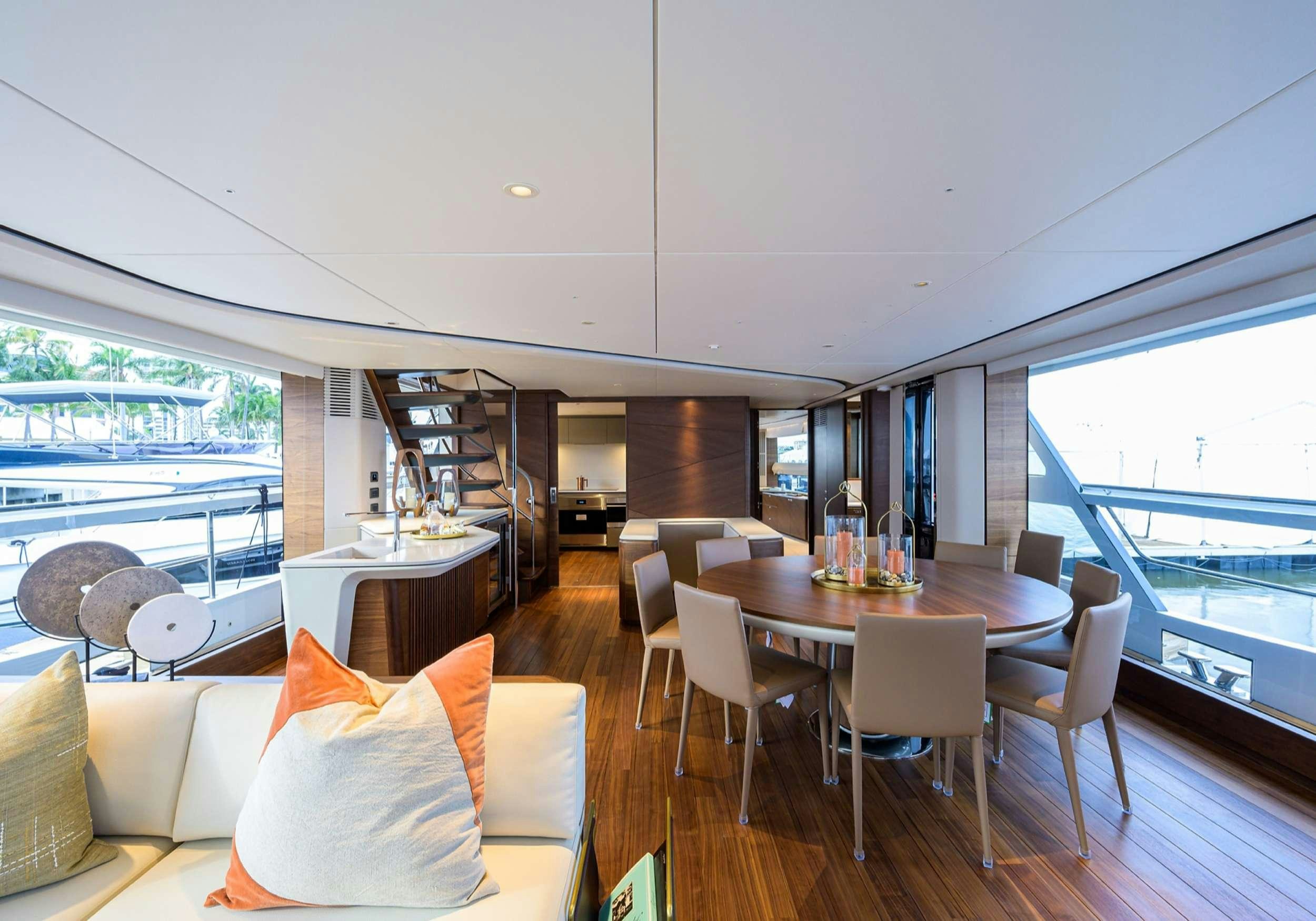 a room with a table chairs and a large window aboard MONOPOLY Yacht for Charter