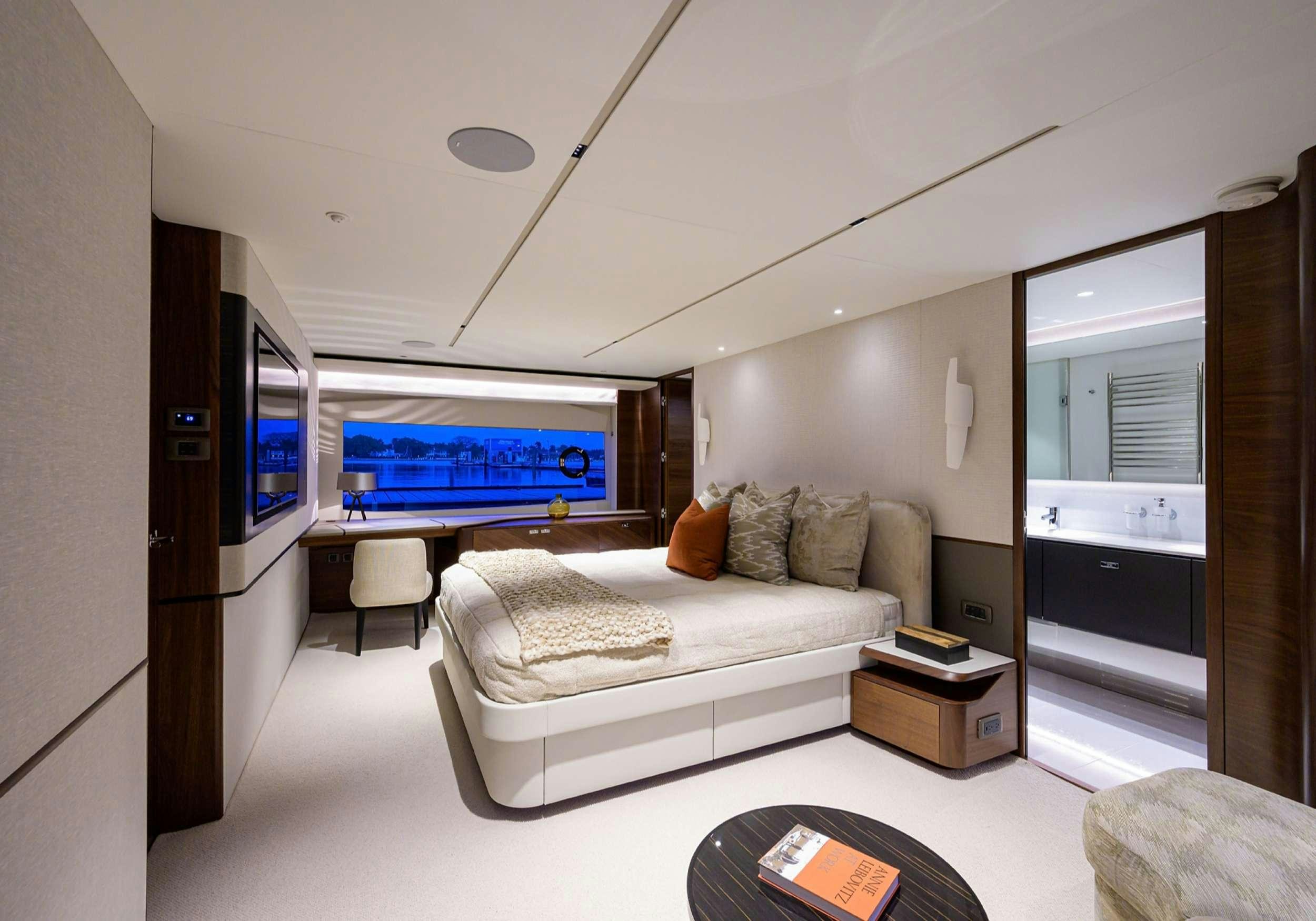 a bedroom with a bed and a tv aboard MONOPOLY Yacht for Charter