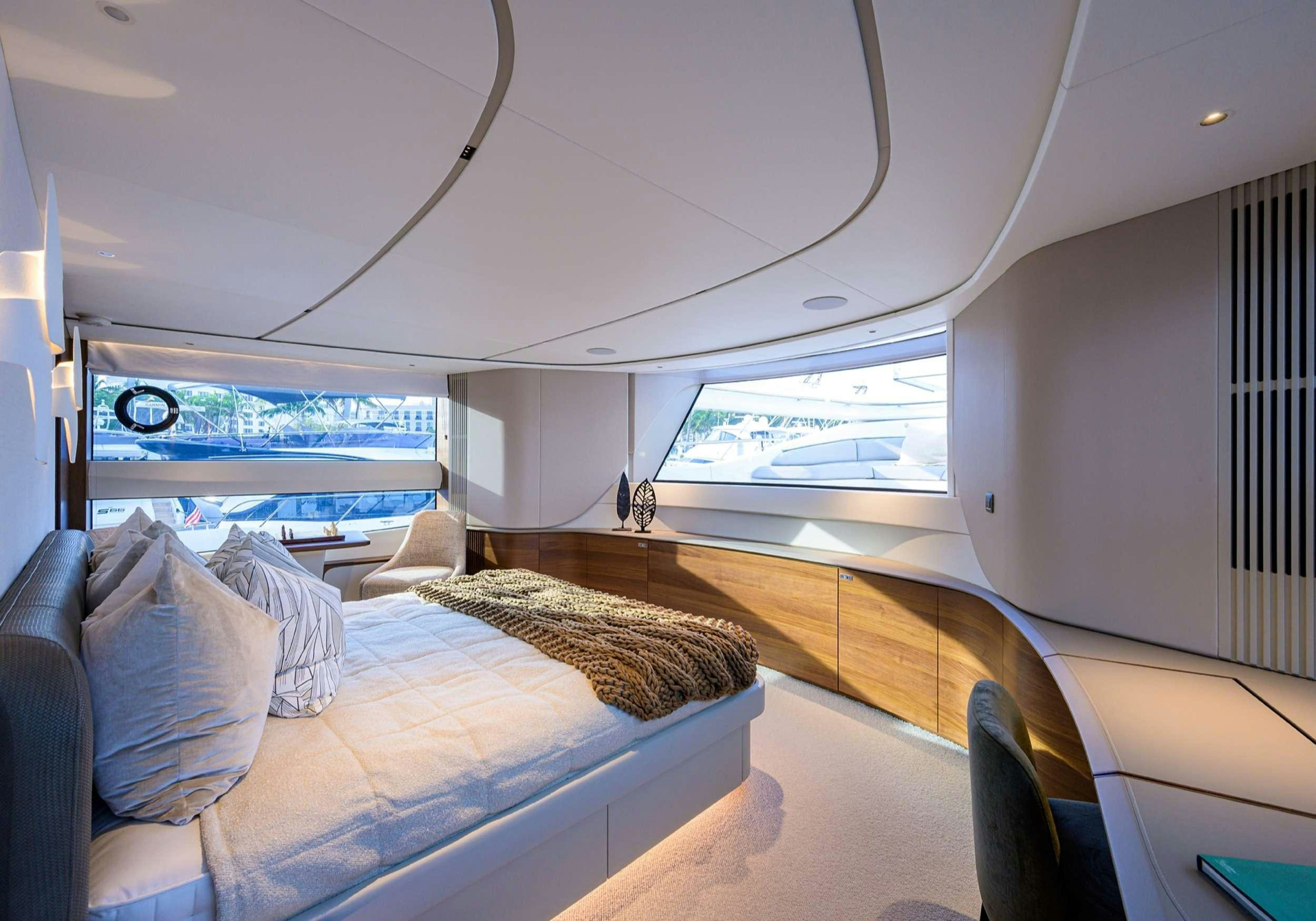 a room with a couch and a window aboard MONOPOLY Yacht for Charter