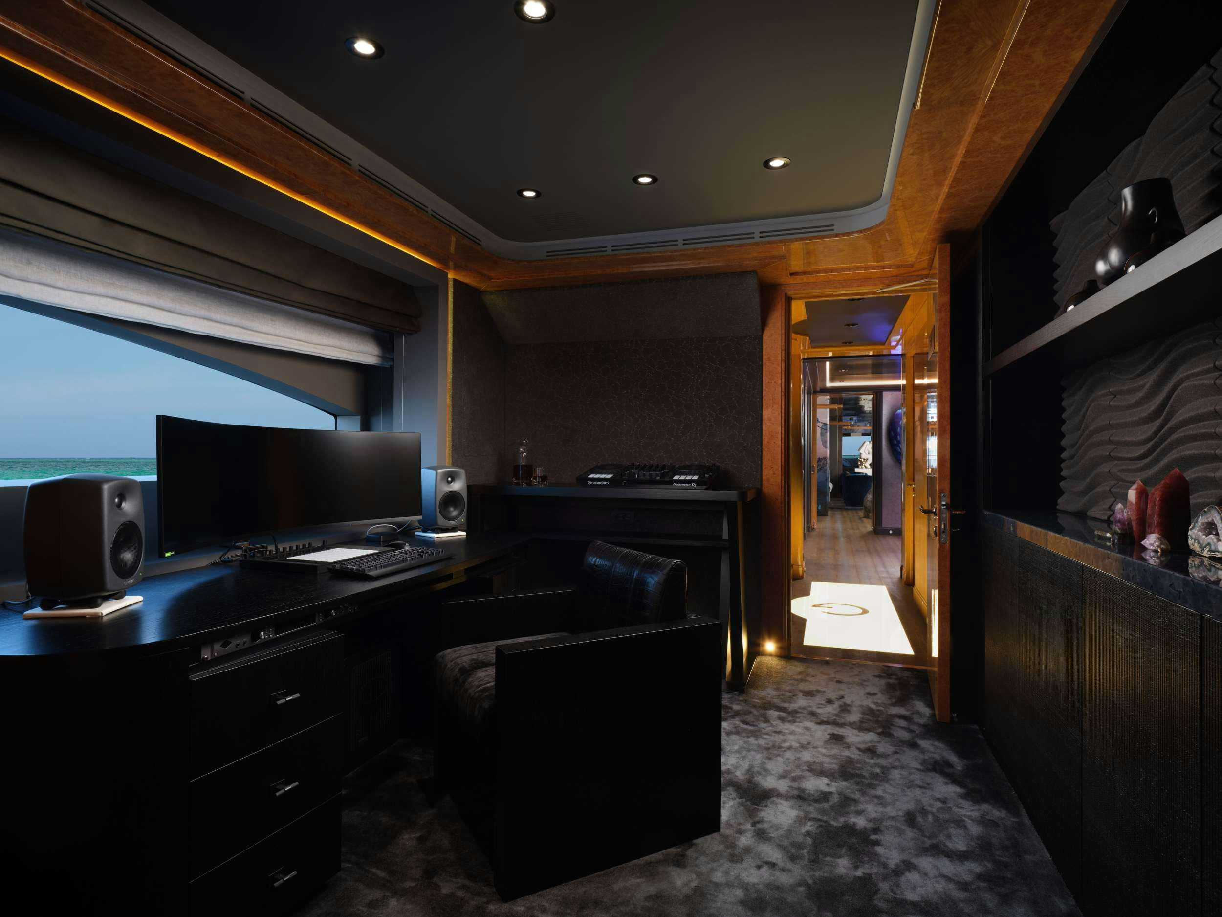 a room with a tv and a dresser aboard GALAXY Yacht for Charter