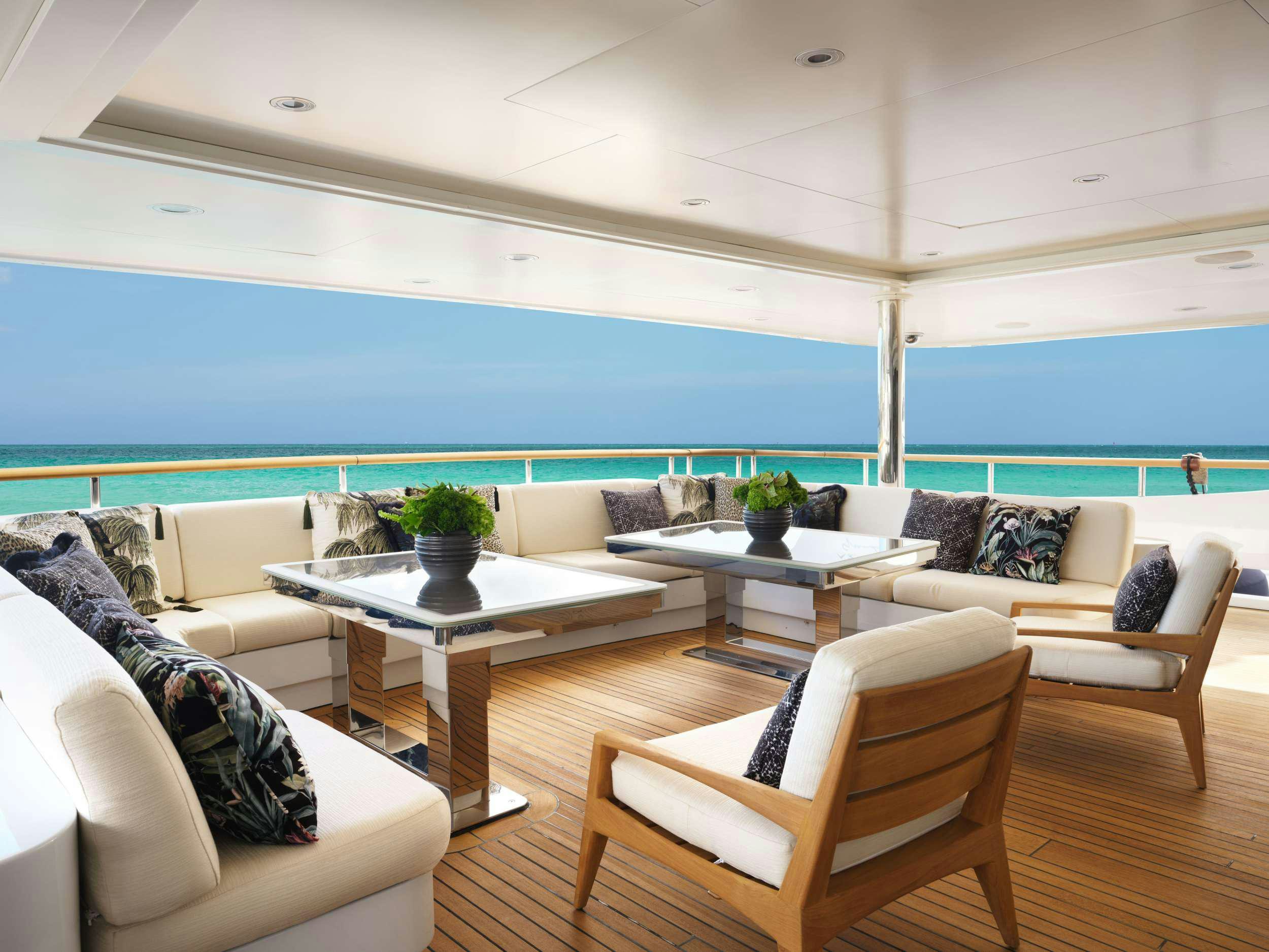 a living room with a large blue ocean aboard GALAXY Yacht for Charter