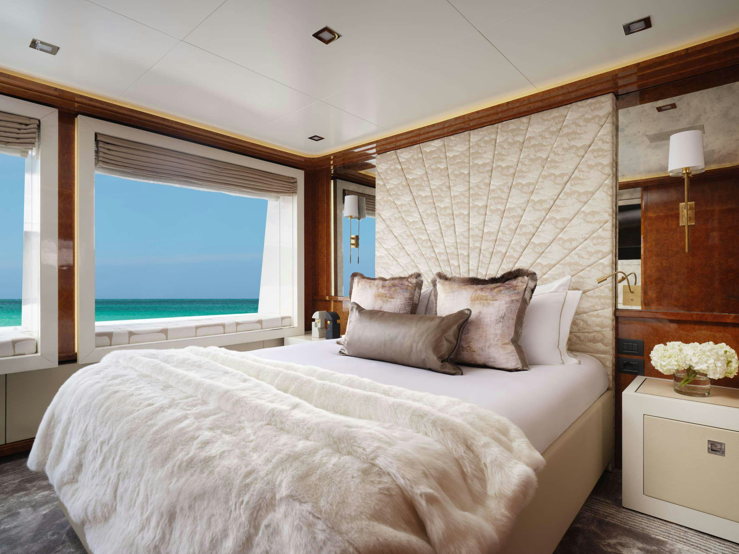 a bed with a white bed spread aboard GALAXY Yacht for Charter