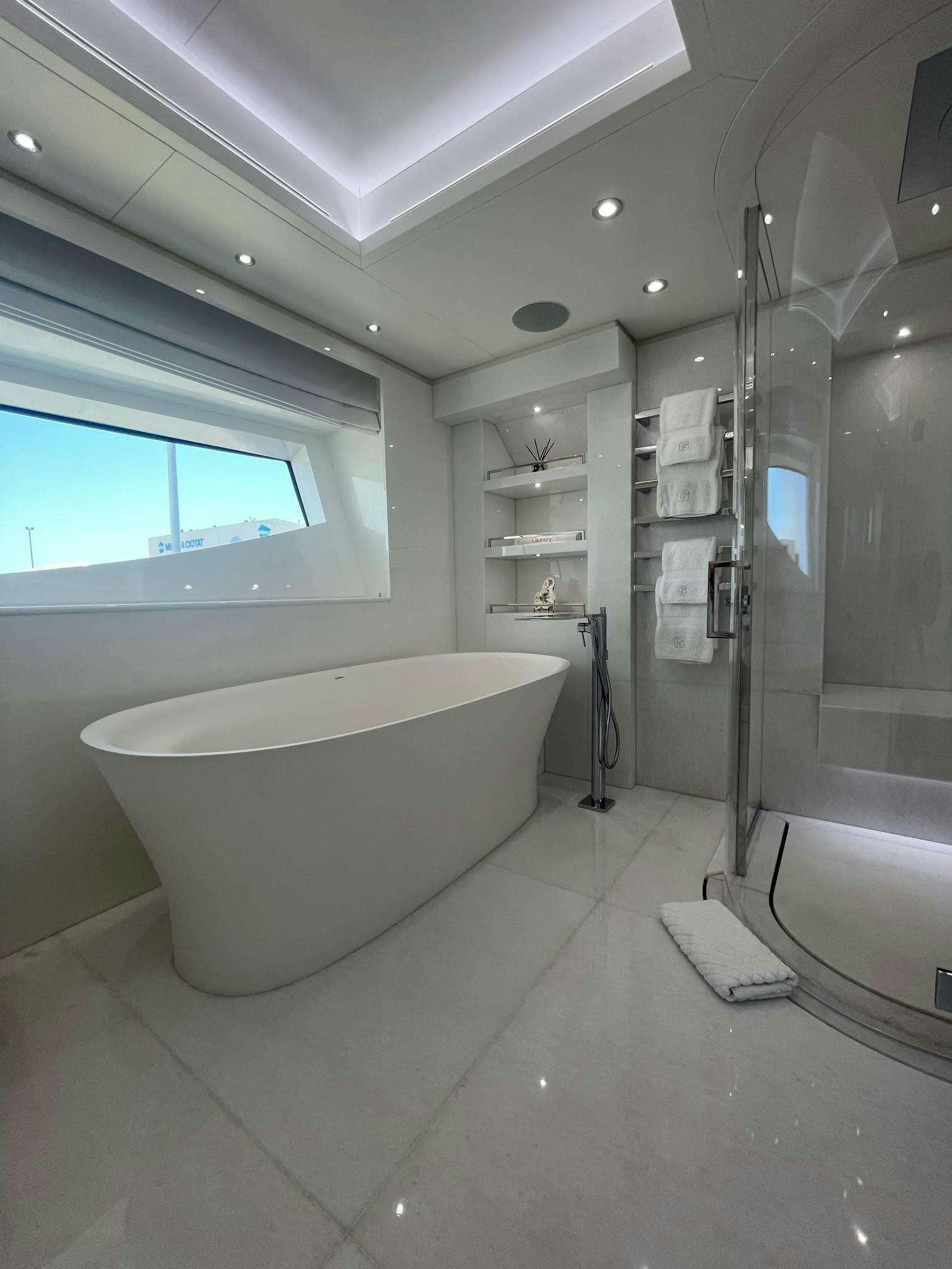 a bathroom with a tub and sink aboard GALAXY Yacht for Charter