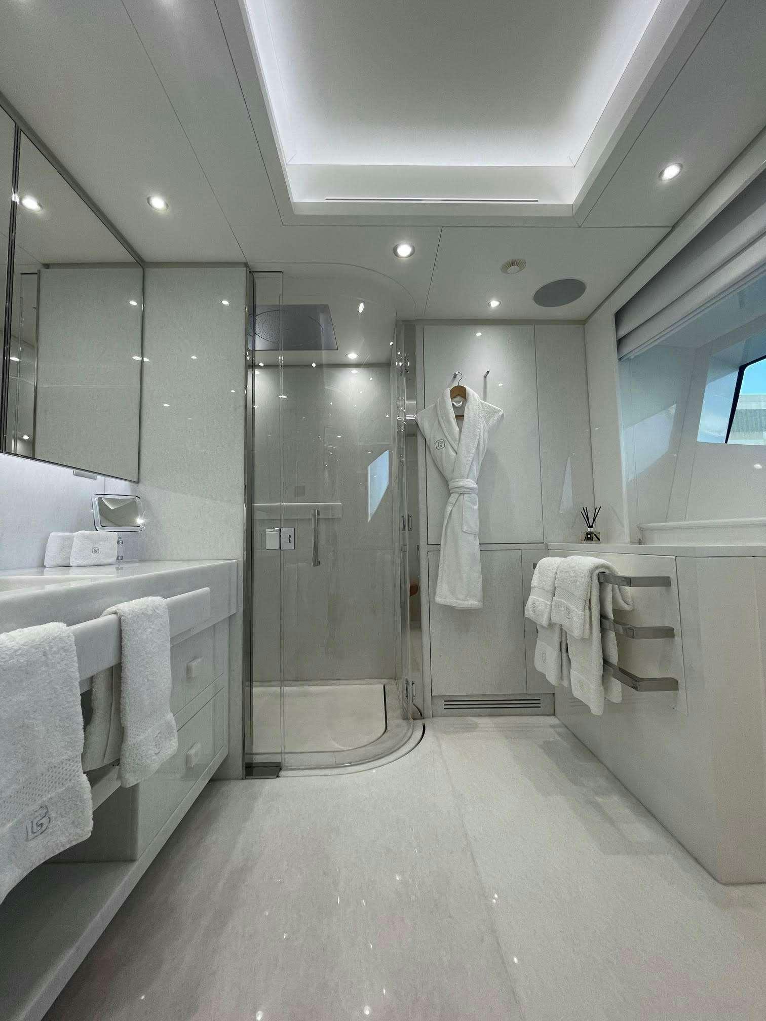a bathroom with a glass shower aboard GALAXY Yacht for Charter