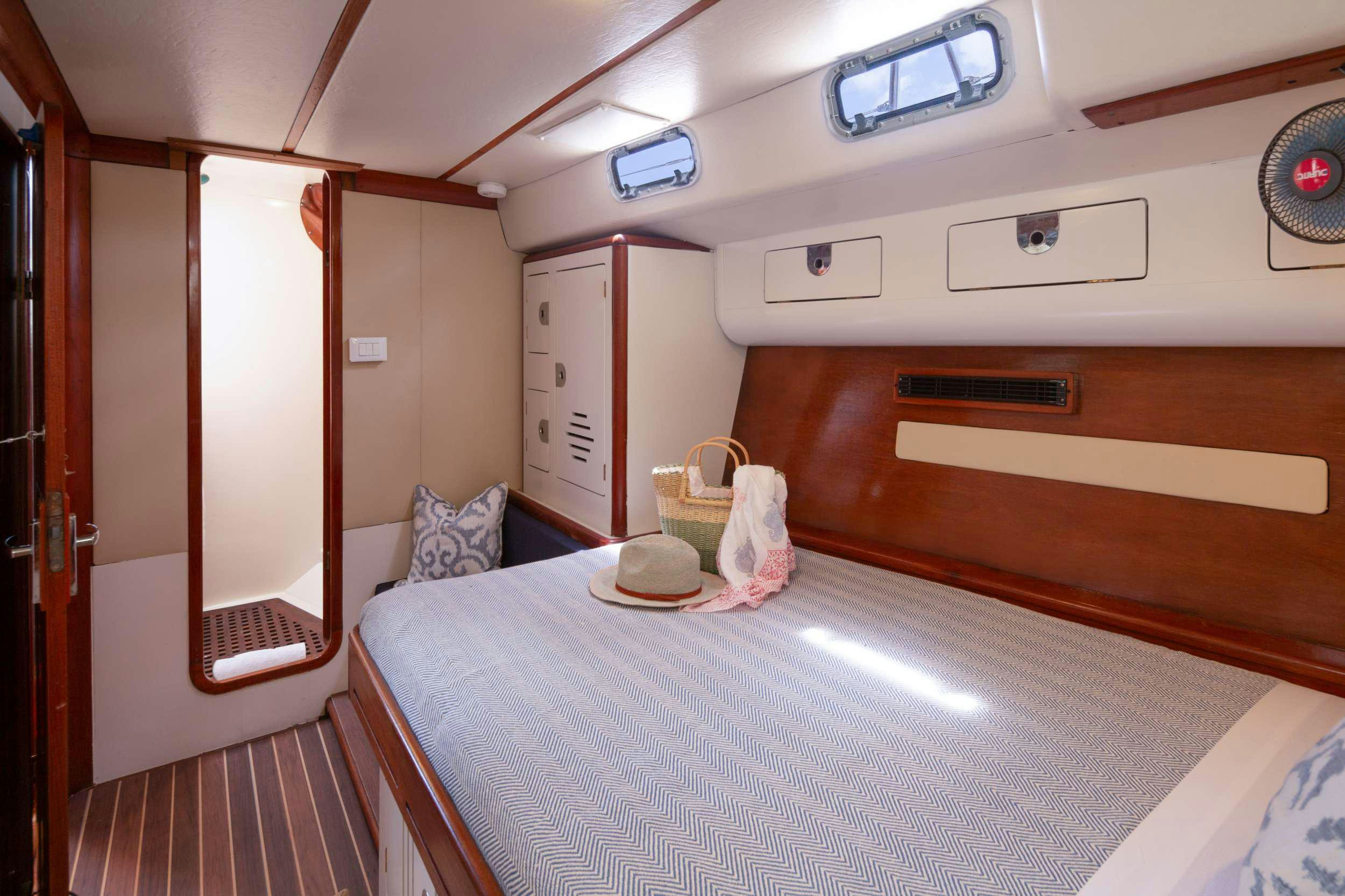 a room with a bed and a window aboard ARROW OF AYR Yacht for Charter