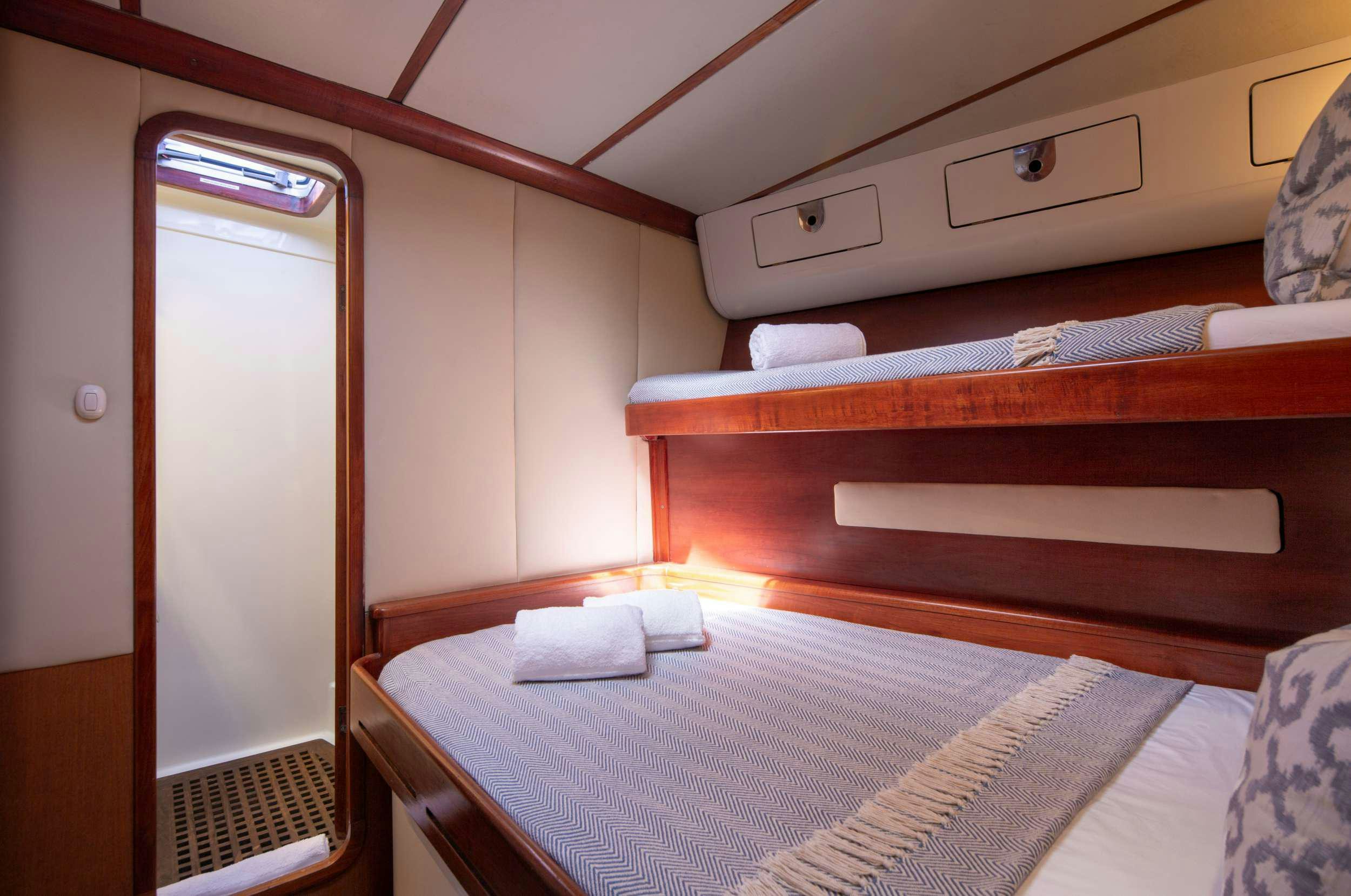 a room with a bed and a closet aboard ARROW OF AYR Yacht for Charter