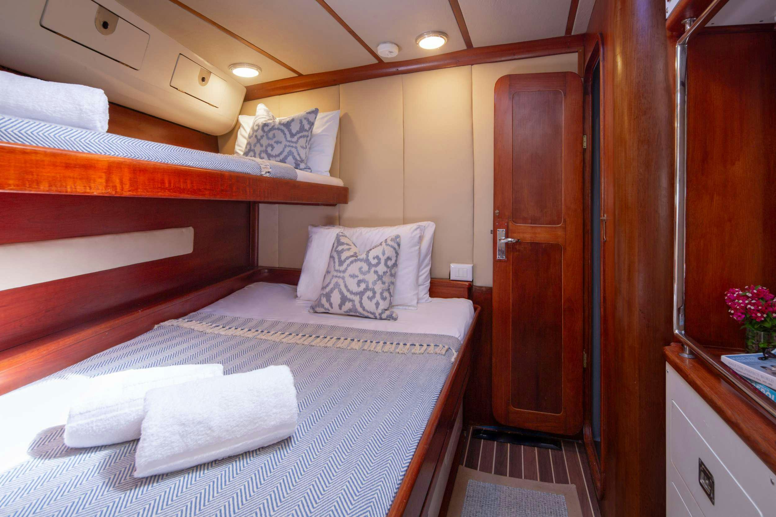 a bed with a white pillow aboard ARROW OF AYR Yacht for Charter