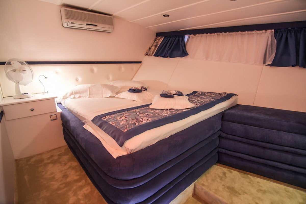 a couple of beds in a room aboard AURUM Yacht for Charter