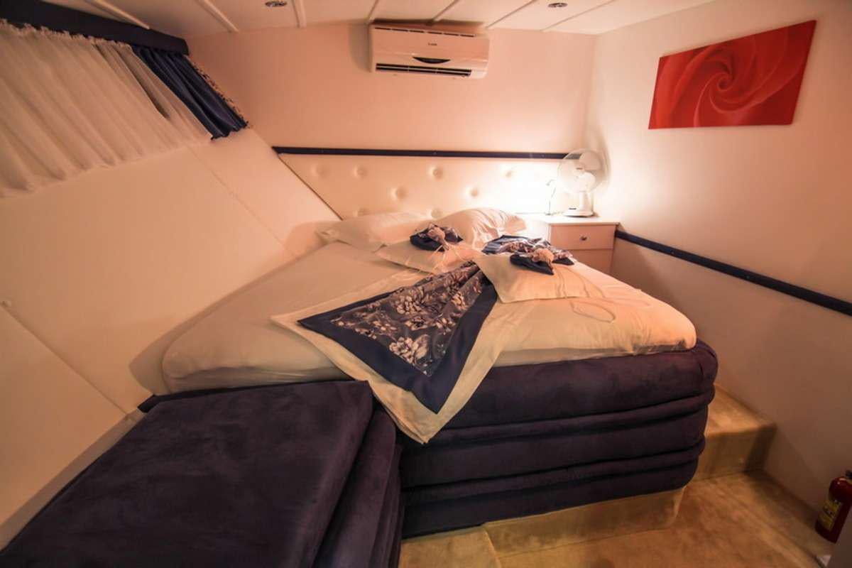a couple of beds in a room aboard AURUM Yacht for Charter