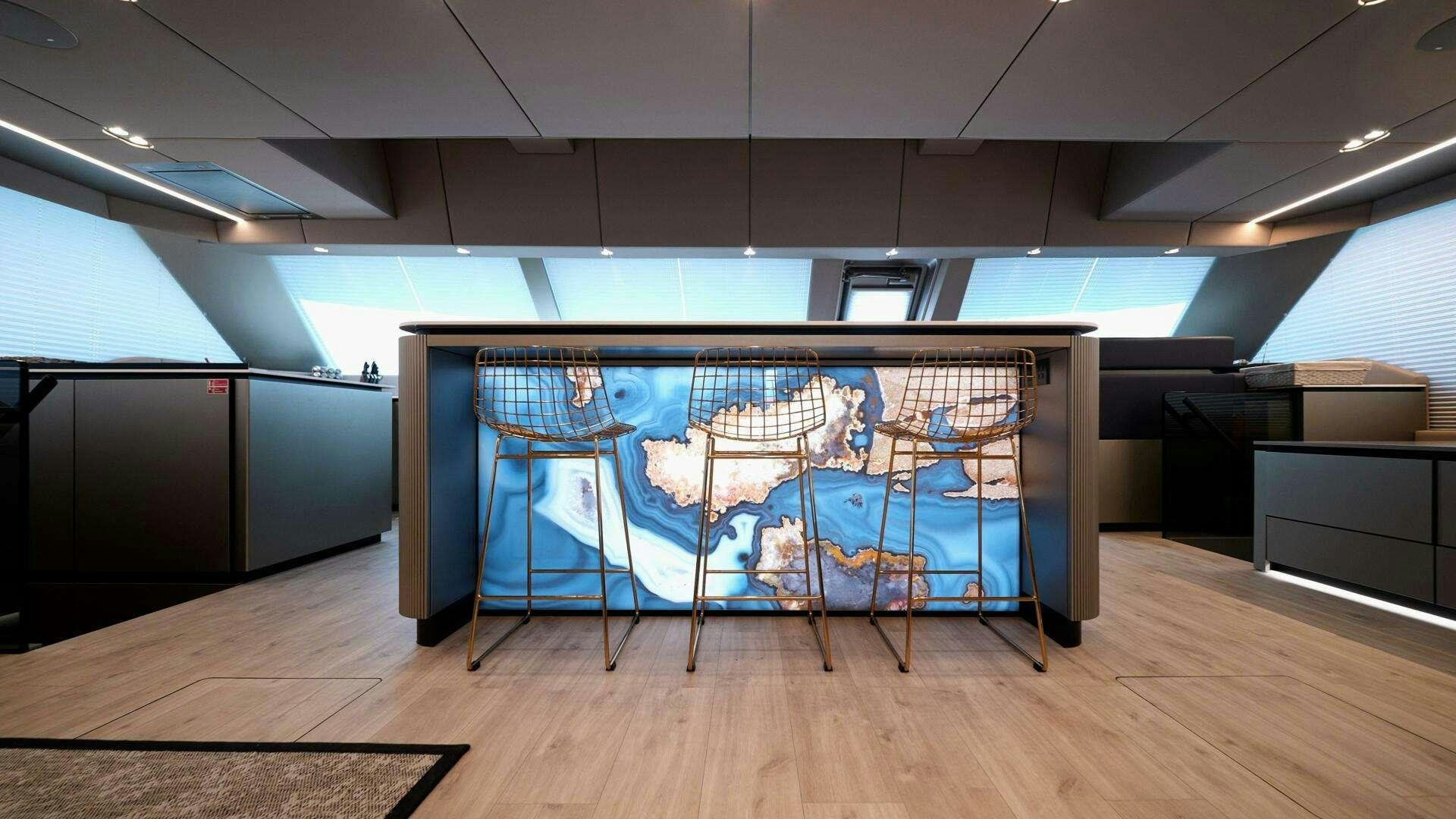 a room with a table and chairs aboard NAUTI NICKEL Yacht for Charter