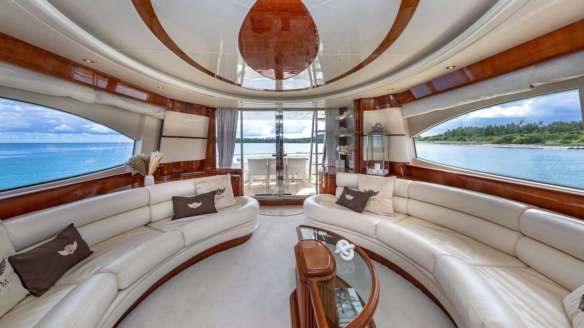 a large living room with a large window and a large bed aboard SALT SHAKER Yacht for Charter