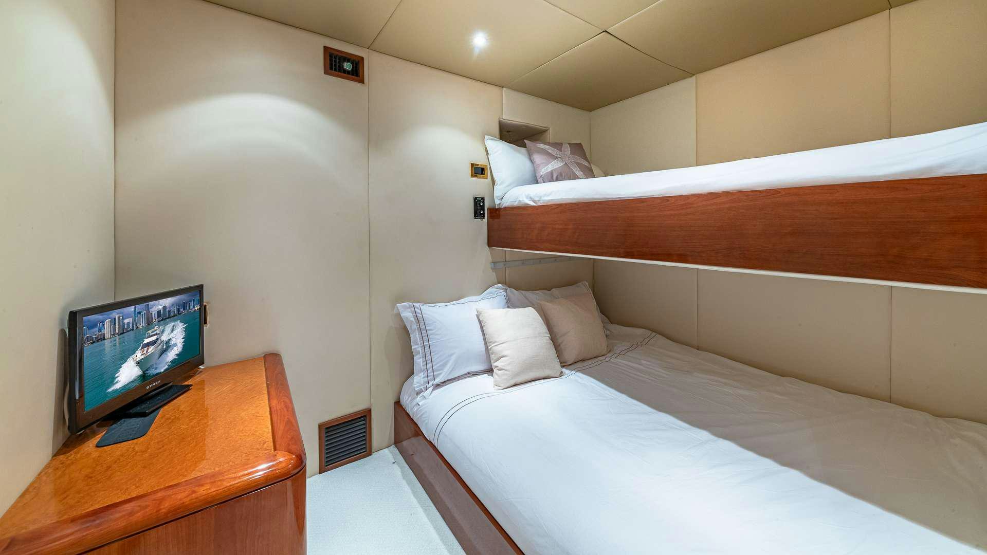 a bed with a television on it aboard SALT SHAKER Yacht for Charter
