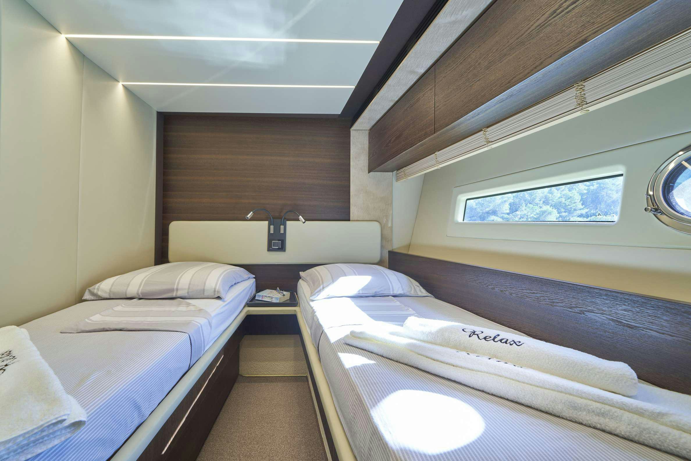 a room with beds and a window aboard AZIMUT 72 - RELAX OF Yacht for Charter