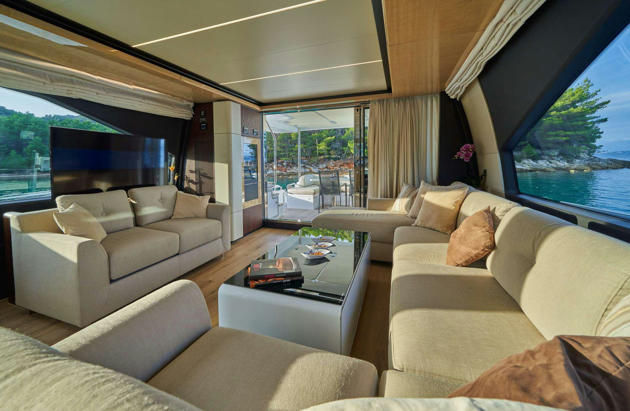 a living room with a large window aboard AZIMUT 72 - RELAX OF Yacht for Charter