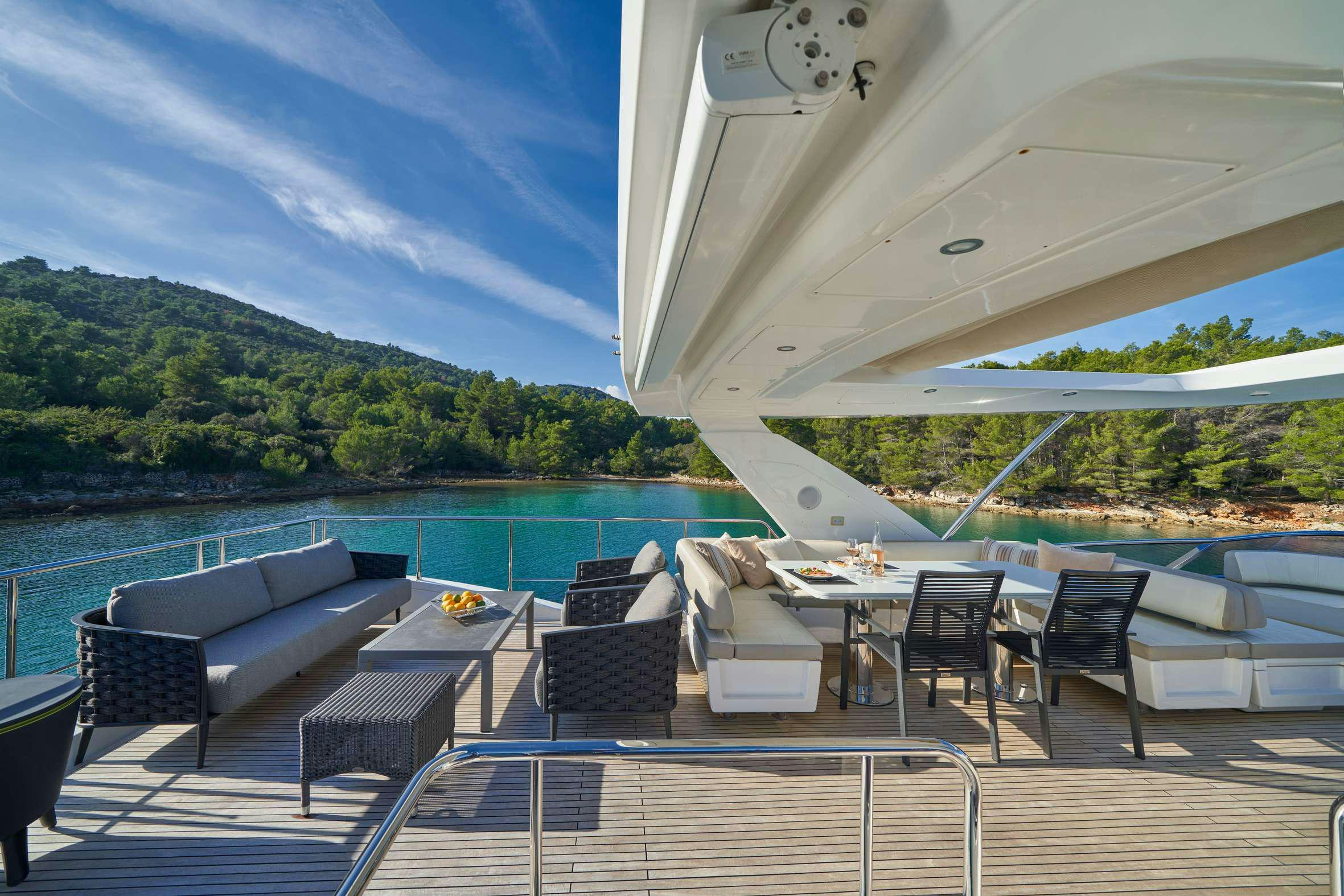 a patio with a pool and a deck with chairs and tables aboard AZIMUT 72 - RELAX OF Yacht for Charter