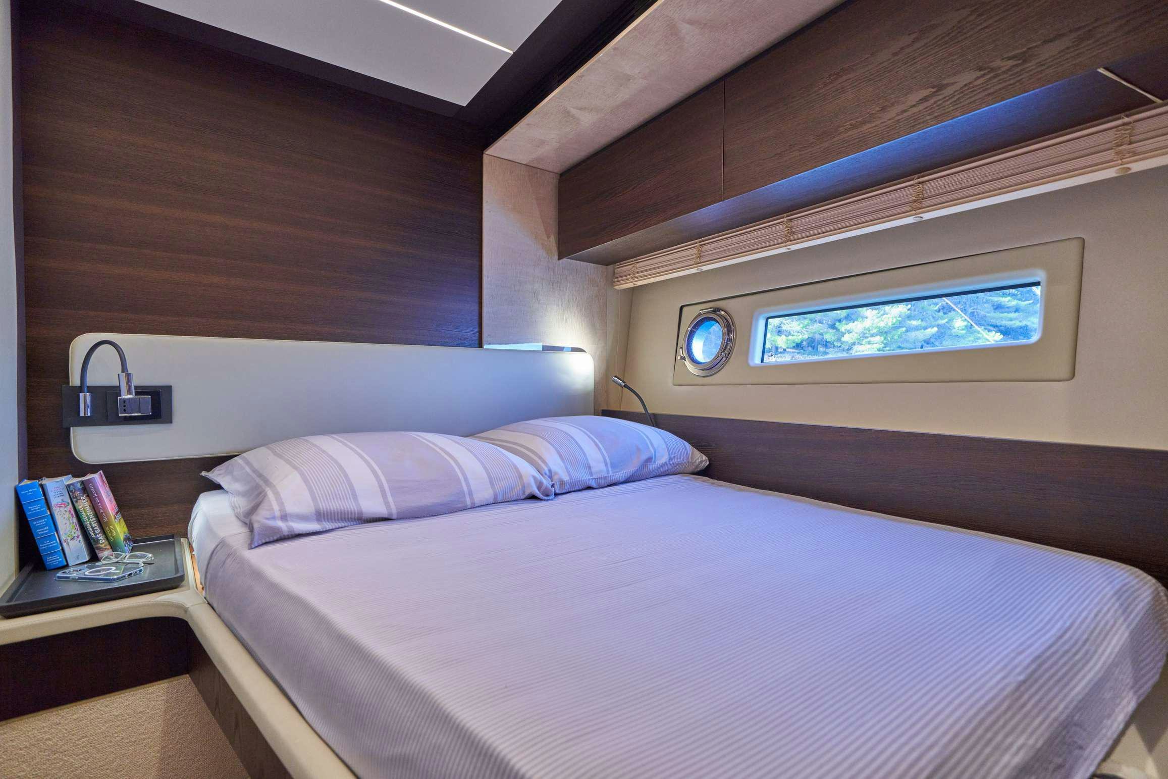 a bed with a white bed spread aboard AZIMUT 72 - RELAX OF Yacht for Charter