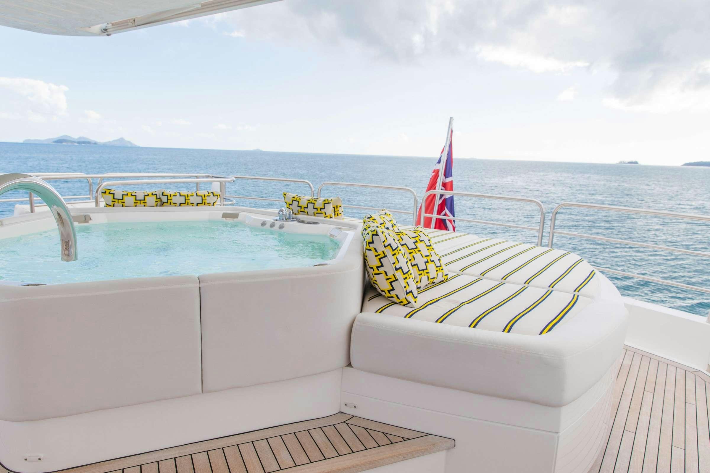a boat with a flag on the front aboard RASCAL Yacht for Charter