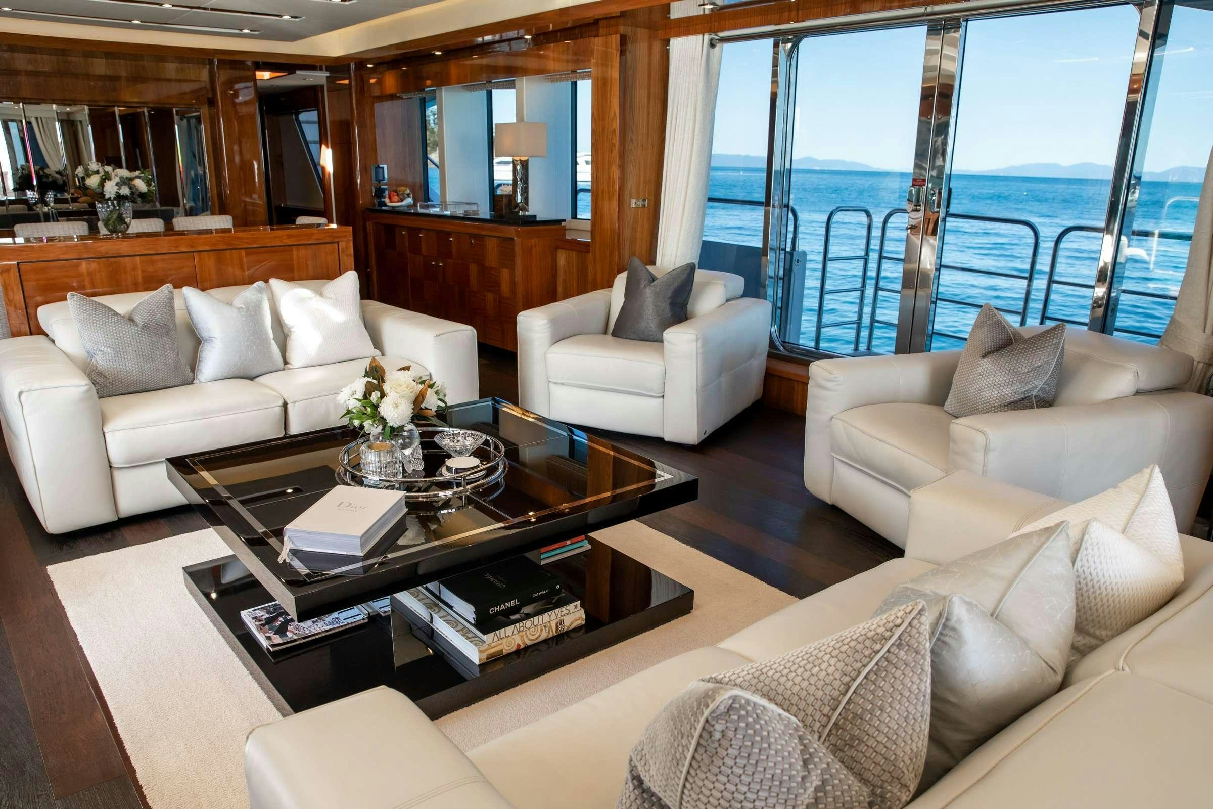 a living room with a large window aboard RASCAL Yacht for Charter