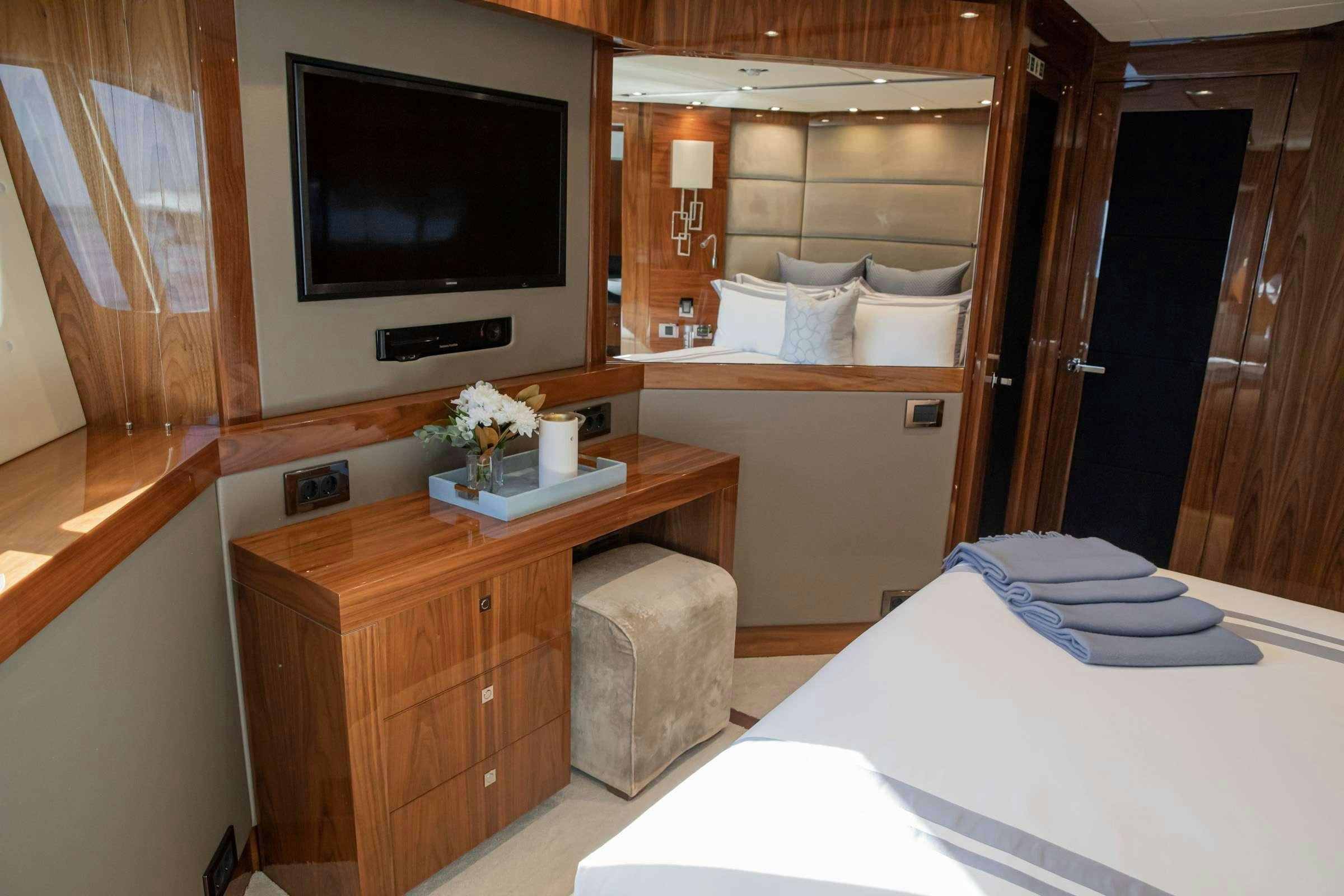 a room with a tv and a bed aboard RASCAL Yacht for Charter