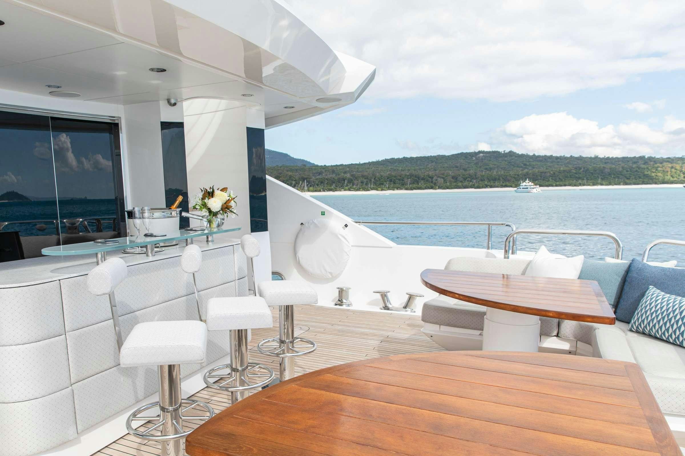 a room with a table and chairs aboard RASCAL Yacht for Charter