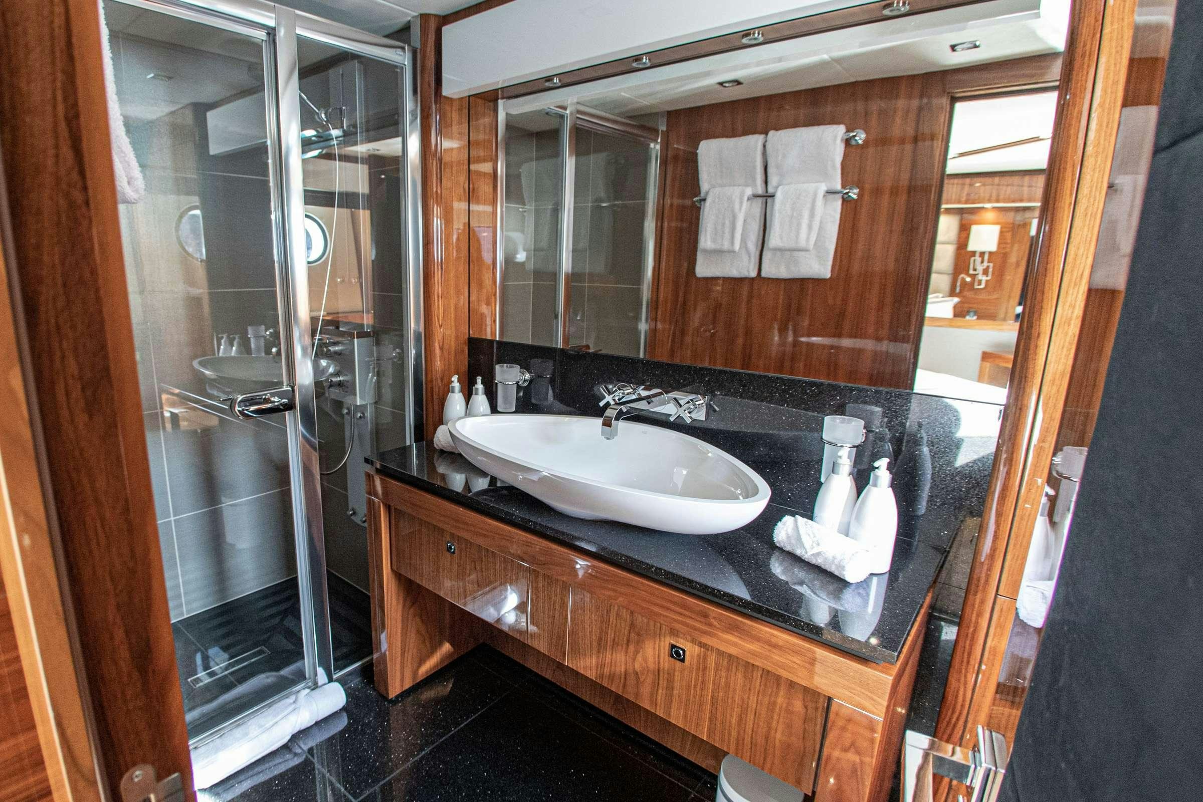 a bathroom with a large mirror aboard RASCAL Yacht for Charter