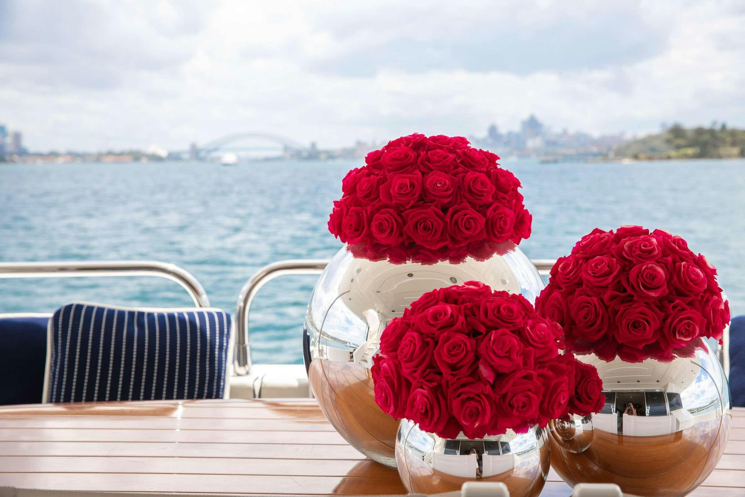 a vase with red flowers aboard CHAOS Yacht for Charter