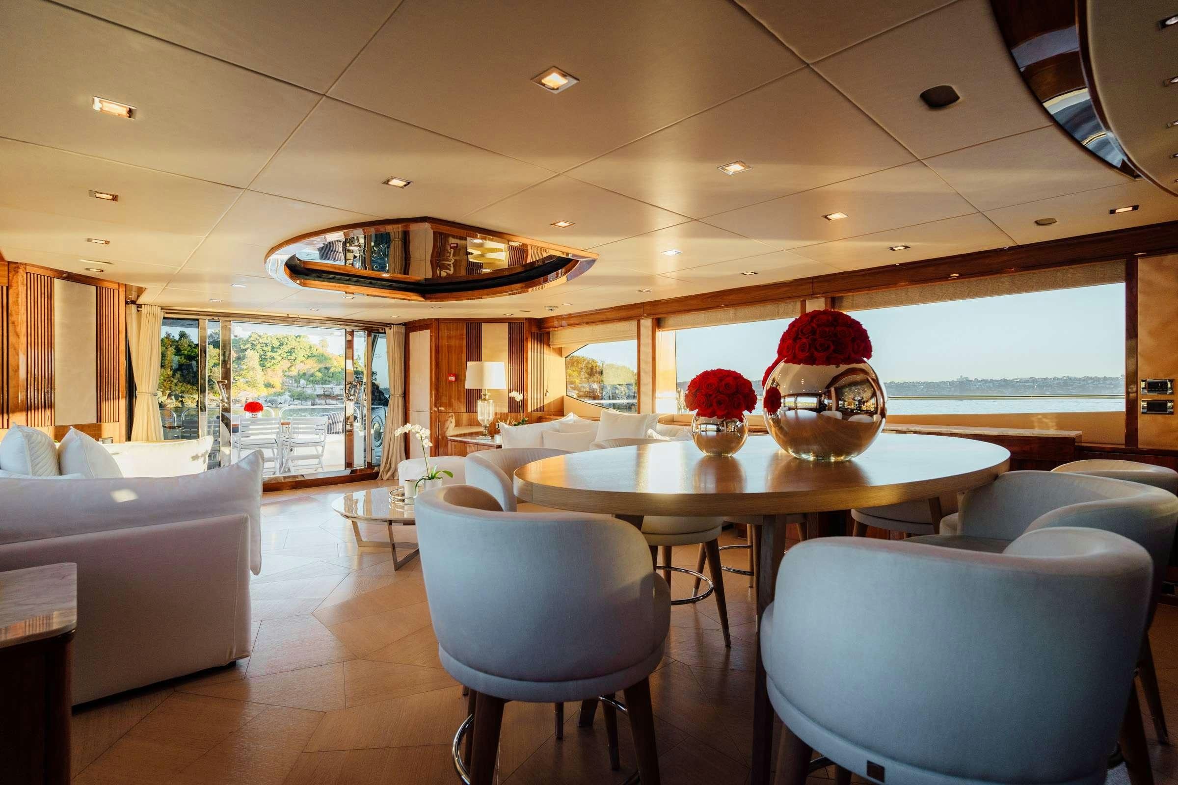 a room with a table and chairs aboard CHAOS Yacht for Charter