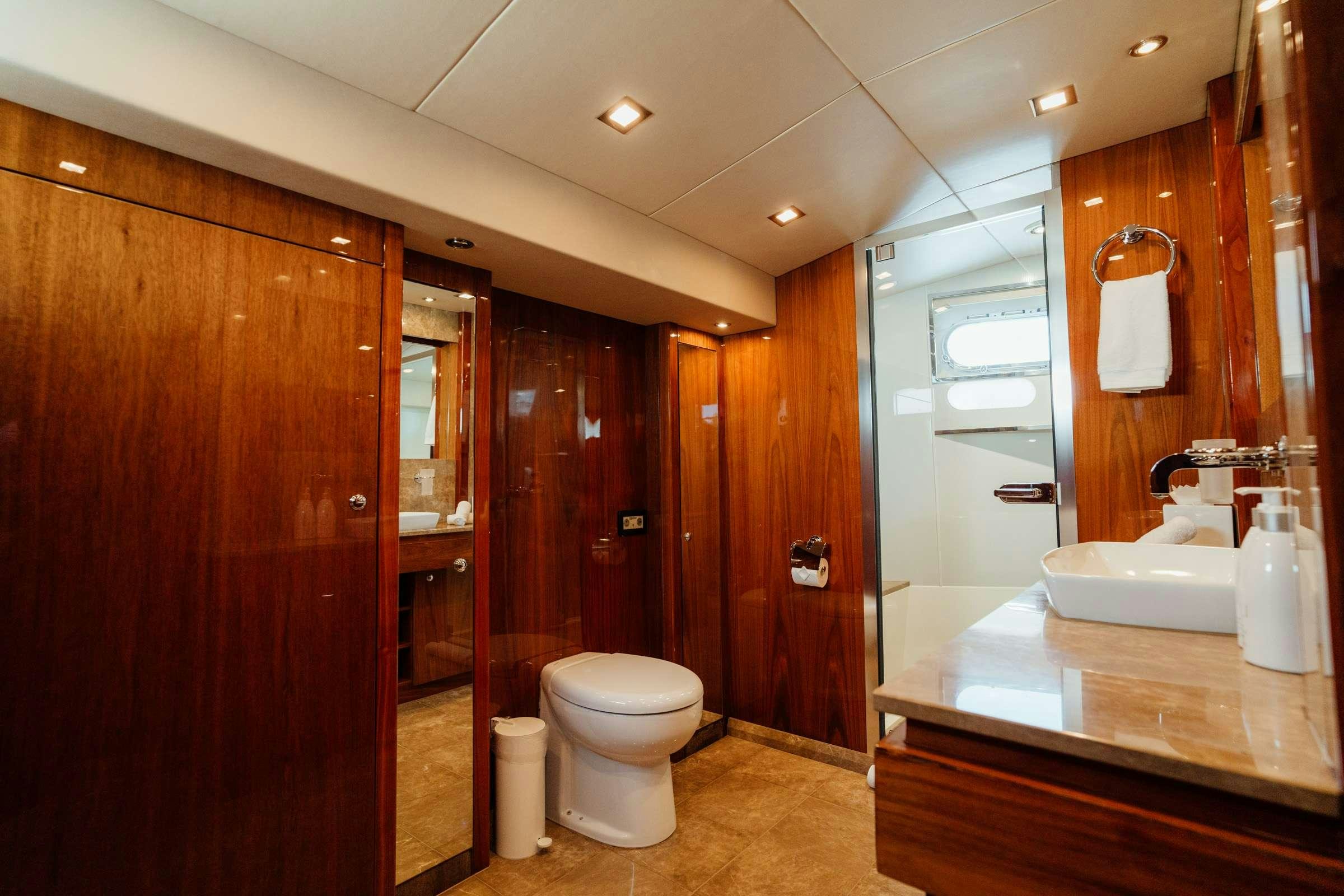 a bathroom with a large mirror aboard CHAOS Yacht for Charter